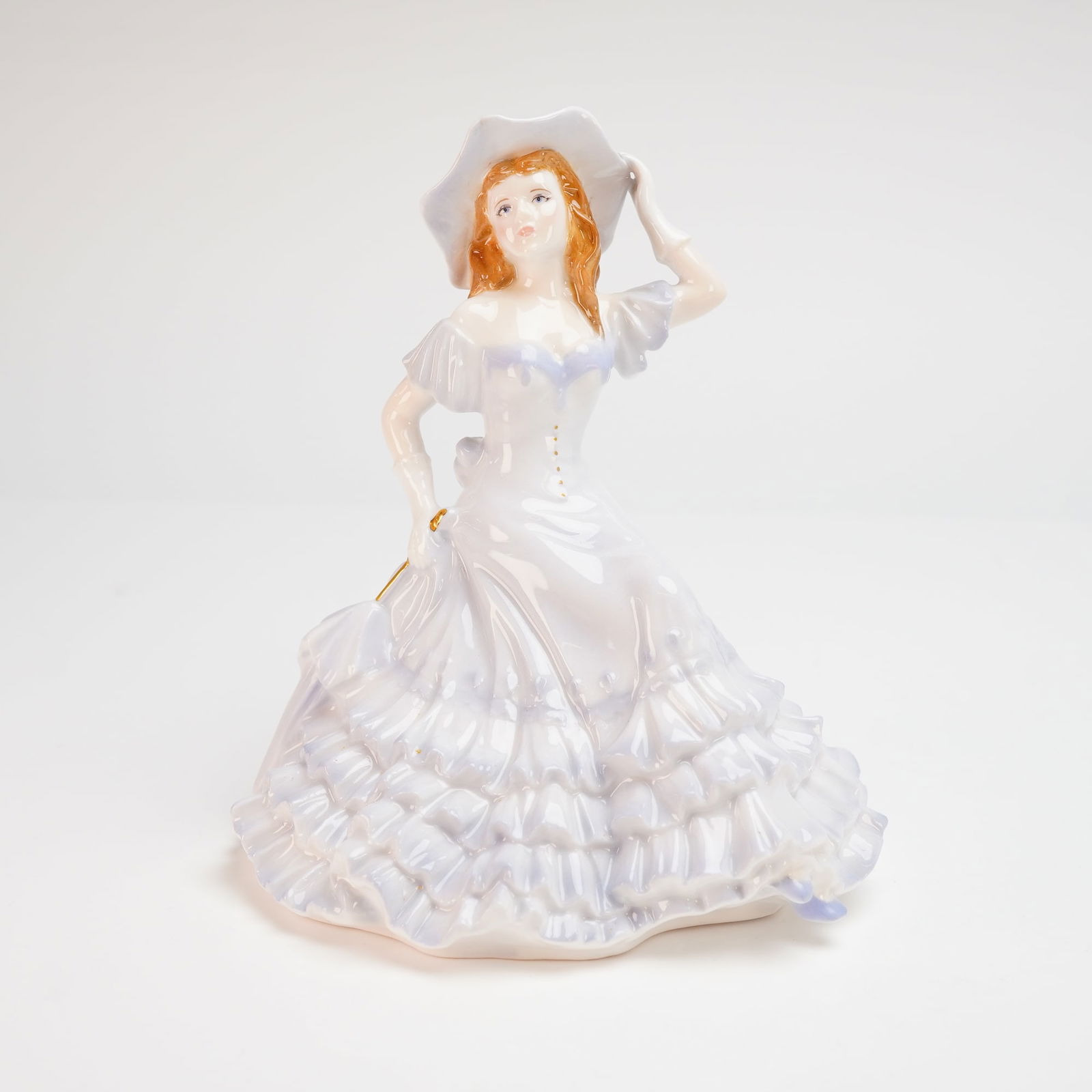Royal Worcester Les Petites Emily Bone China Figurine: This Royal Worcester fine bone china figurine, titled Emily, is part of the Les Petites collection. Modeled by Jack Glynn, the figure depicts a young woman with reddish hair wearing a wide-brimmed hat