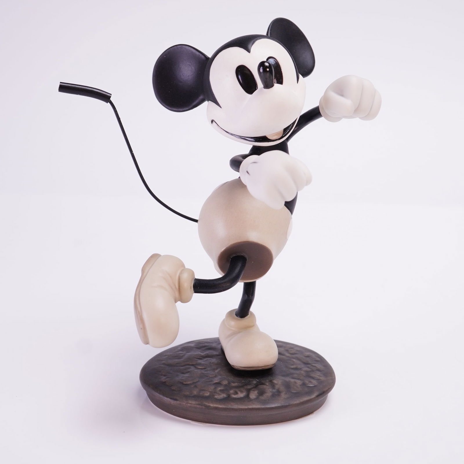 WDCC Mickey Mouse Hey Minnie Wanna Go Steppin Delivery Boy Figurine: A Walt Disney Classics Collection porcelain figurine titled Hey Minnie, Wanna Go Steppin from Walt Disney's The Delivery Boy. This monochromatic cream and black figurine depicts Mickey Mouse in a dyna