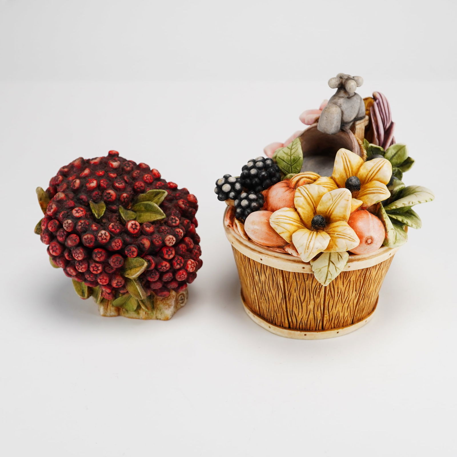 2pc Harmony Kingdom Box Figurines, Fall Bouquet & Cranberry: The Fall Bouquet box is designed as a wood-textured basket filled with fruit and flowers, featuring a small grey mouse on top. The Cranberry box is rendered as a cluster of red berries with green leav