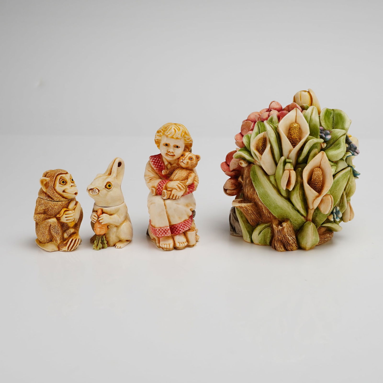 4pc Harmony Kingdom Box Figurines: A collection of Harmony Kingdom hand-painted cast resin box figurines, featuring pieces from the Lord Byron's Harmony Garden and Angelique series. The group includes the Spring Bouquet floral arrangem