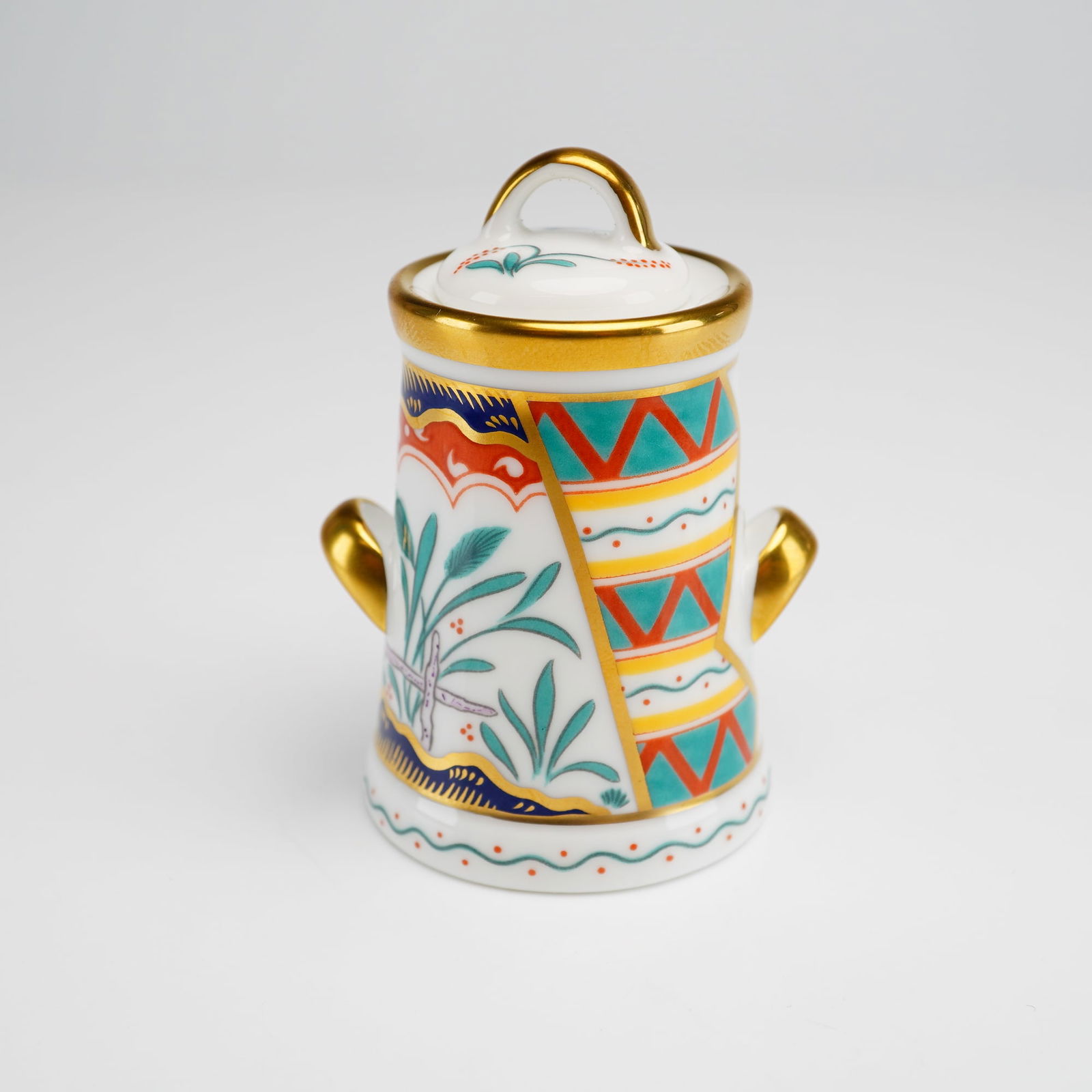Royal Crown Derby Bone China Miniature Milk Churn, Tree of Life: A Royal Crown Derby fine bone China miniature milk churn figurine decorated in the Tree of Life pattern. The lidded jar of churn form features twin side handles and a loop finial. The body is ornament