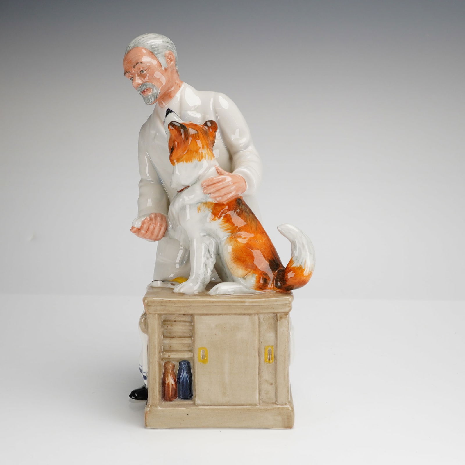 Royal Doulton Figurine Thanks Doc! HN2731: A Royal Doulton glazed porcelain figurine titled Thanks Doc!, model number HN2731. The piece depicts a narrative scene featuring an elderly veterinarian with gray hair and a beard in a long white lab