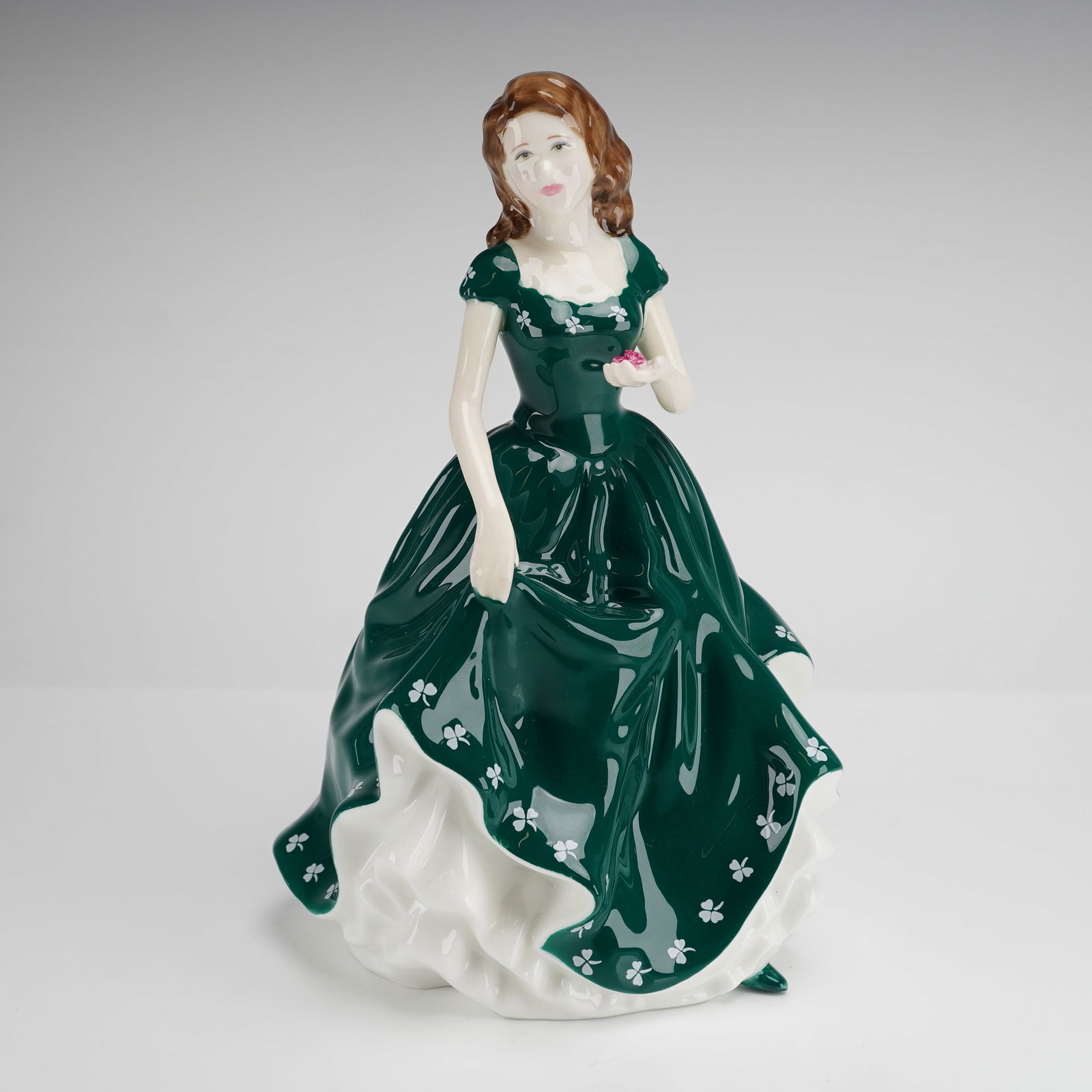 Royal Doulton Irish Charm Figurine HN4580: A hand-made and hand-decorated bone china figurine titled Irish Charm, produced by Royal Doulton as part of the Classics collection. The figure, model HN 4580, was designed by Nada M. Pedley and featu