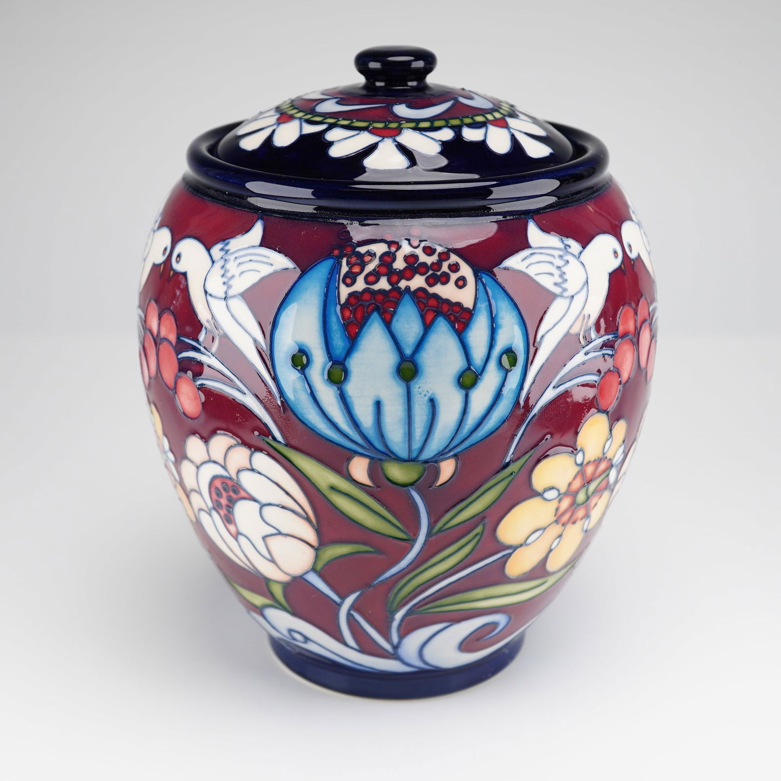 Moorcroft Pottery Chasuble Limited Edition Ginger Jar and Cover: A Moorcroft Pottery limited edition ginger jar and cover in the Chasuble pattern. The vessel features the companys signature tube-lined decoration, showcasing a design of stylized white birds, large