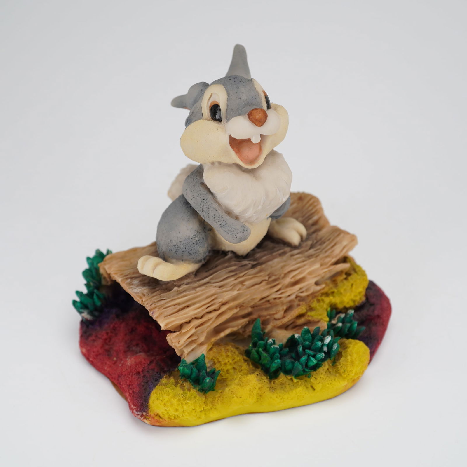 Walt Disney Classics Bambi Thumper Figurine Arden Sculptures: A single figural collectible sculpture, attributed to Arden Sculptures for the Walt Disney Classics collection. The piece depicts the Disney character Thumper from the film Bambi, seated atop a styliz