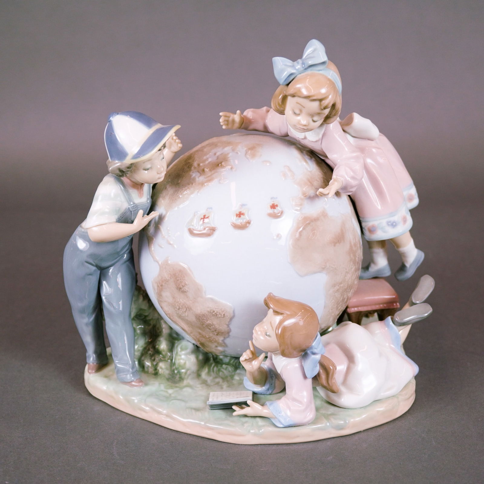 Lladro, The Voyage of Columbus: A limited edition Lladro glossy porcelain figurine, model number 5847, titled The Voyage of Columbus (El Viaje de Colon). This sculptural group features three children, a boy in overalls and two girls
