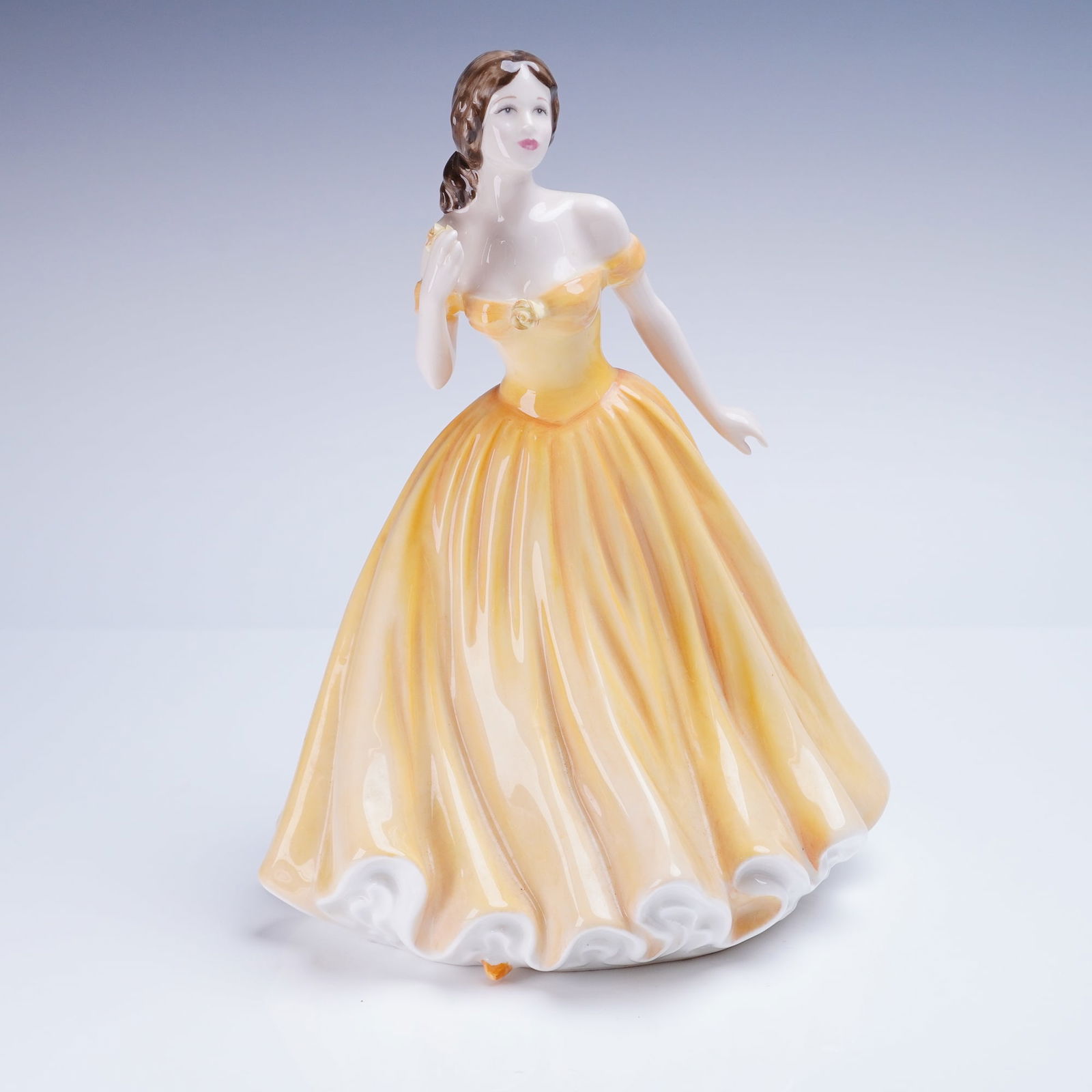 Royal Doulton Figurine Elizabeth Figure of the Year 2003 HN 4426: A bone china figurine by Royal Doulton, titled "Elizabeth," Figure of the Year 2003, model number HN 4426. The figure is hand-made and hand-decorated, depicting a woman in an off-the-shoulder ballgown