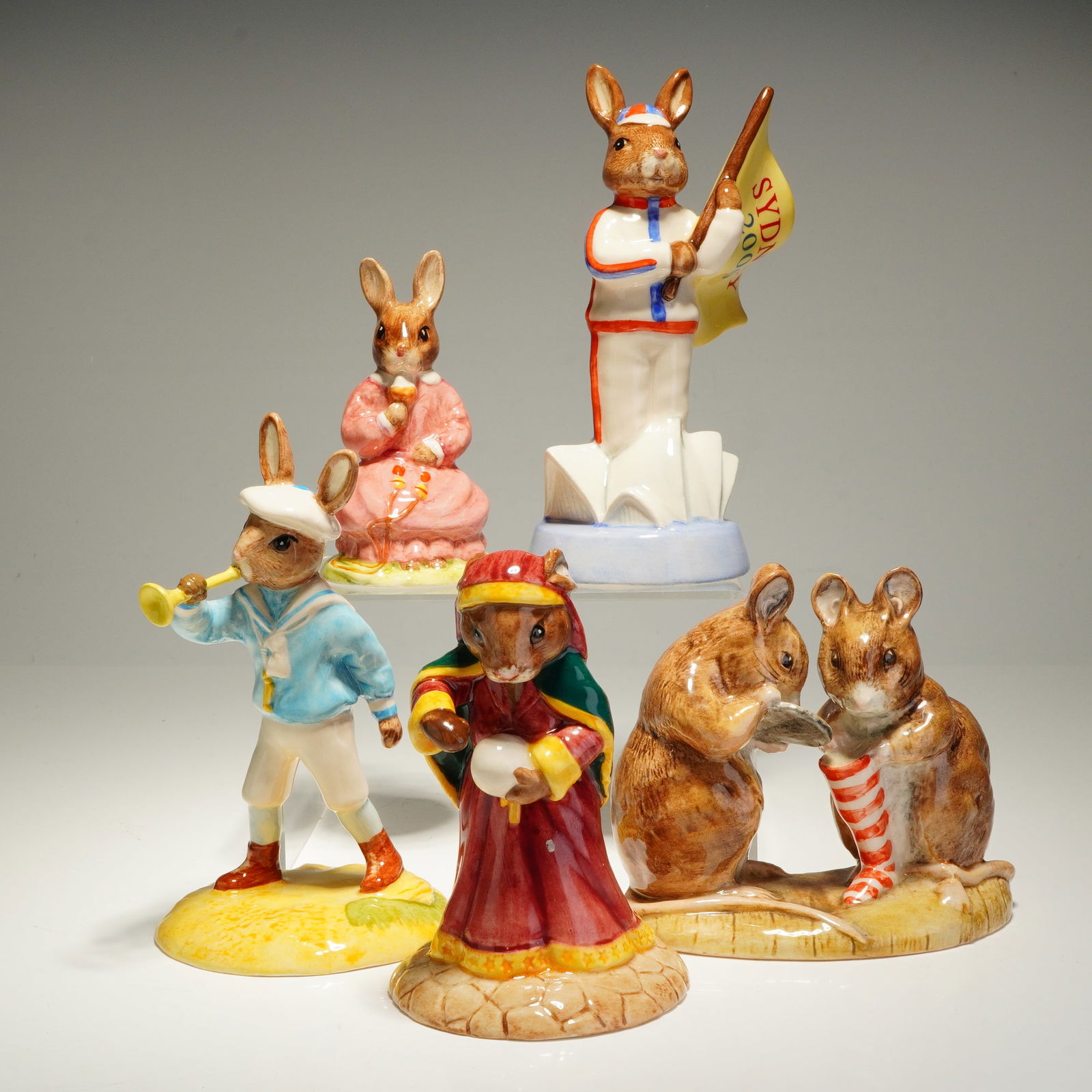 5 Royal Doulton Bunnykins and Royal Albert Beatrix Potter Figurines: This collection consists of 5 glazed ceramic figurines from the Royal Doulton Bunnykins and Royal Albert Beatrix Potter series. The group includes one Royal Albert Beatrix Potter figurine titled The C