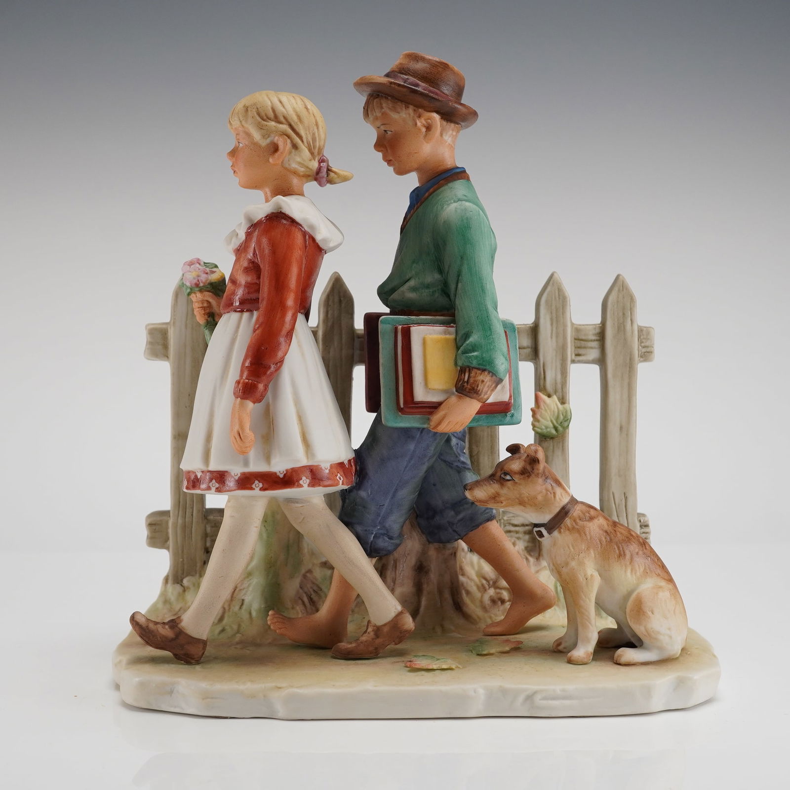 Gorham Norman Rockwell First Edition Figurine A Scholarly Pace Fall 1949: A glazed porcelain figural grouping manufactured by Gorham, inspired by Norman Rockwell's Four Seasons illustrations for 1949. This selection, titled "A Scholarly Pace," represents the Fall season and