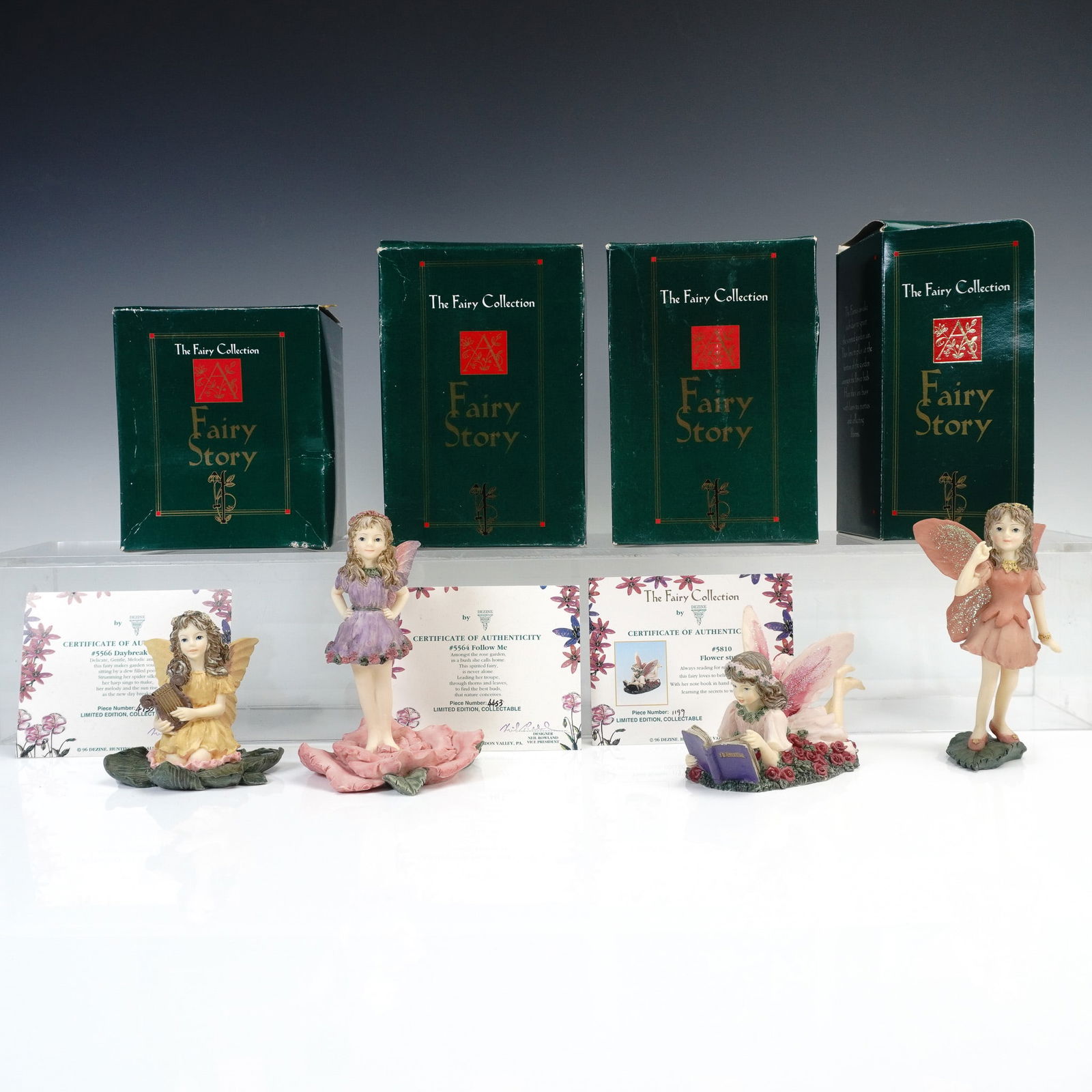 4pc Dezine The Fairy Collection Figurines, with Boxes: Set of four limited edition hand painted resin figurines from The Fairy Collection by Dezine Ltd. Titles include Thoughtful Fairy item 5594, Follow Me item 5564, Daybreak Fairy item 5566, and Flower S