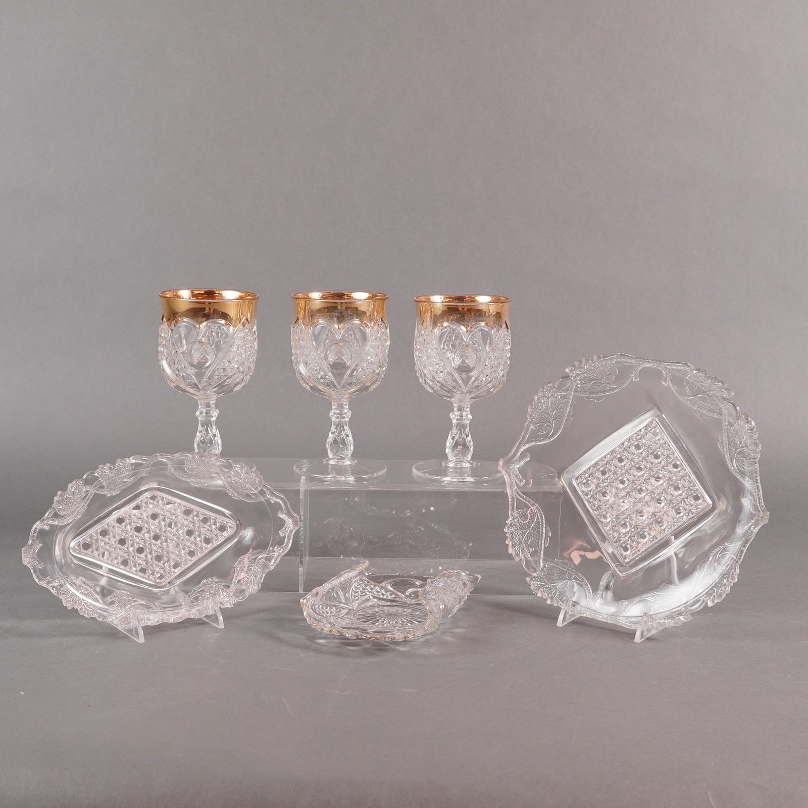 Tarentum Glass Co. Heart with Thumbprint EAPG Collection, 6 Pieces: A collection of six pieces of Early American Pressed Glass (EAPG) manufactured by the Tarentum Glass Company in the Heart with Thumbprint pattern, accented with applied gold trim. The collection