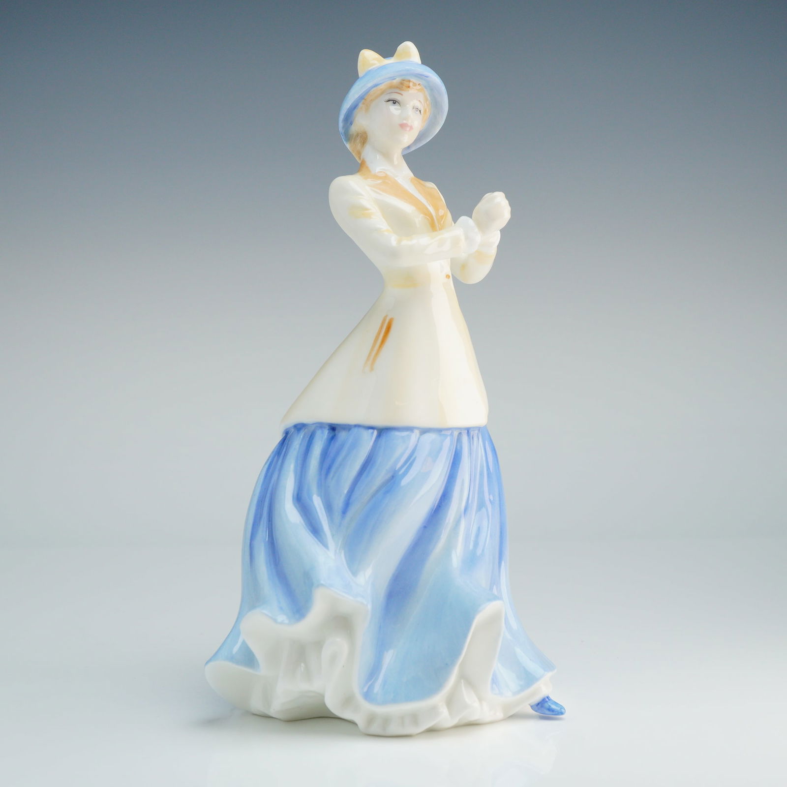 Royal Doulton Figurine, Hannah HN4407: This figure was designed by M. Pedley is part of the Classics Collection and features a copyright date of 2001. The figurine depicts a woman in early 20th-century dress, wearing a cream-colored jacket