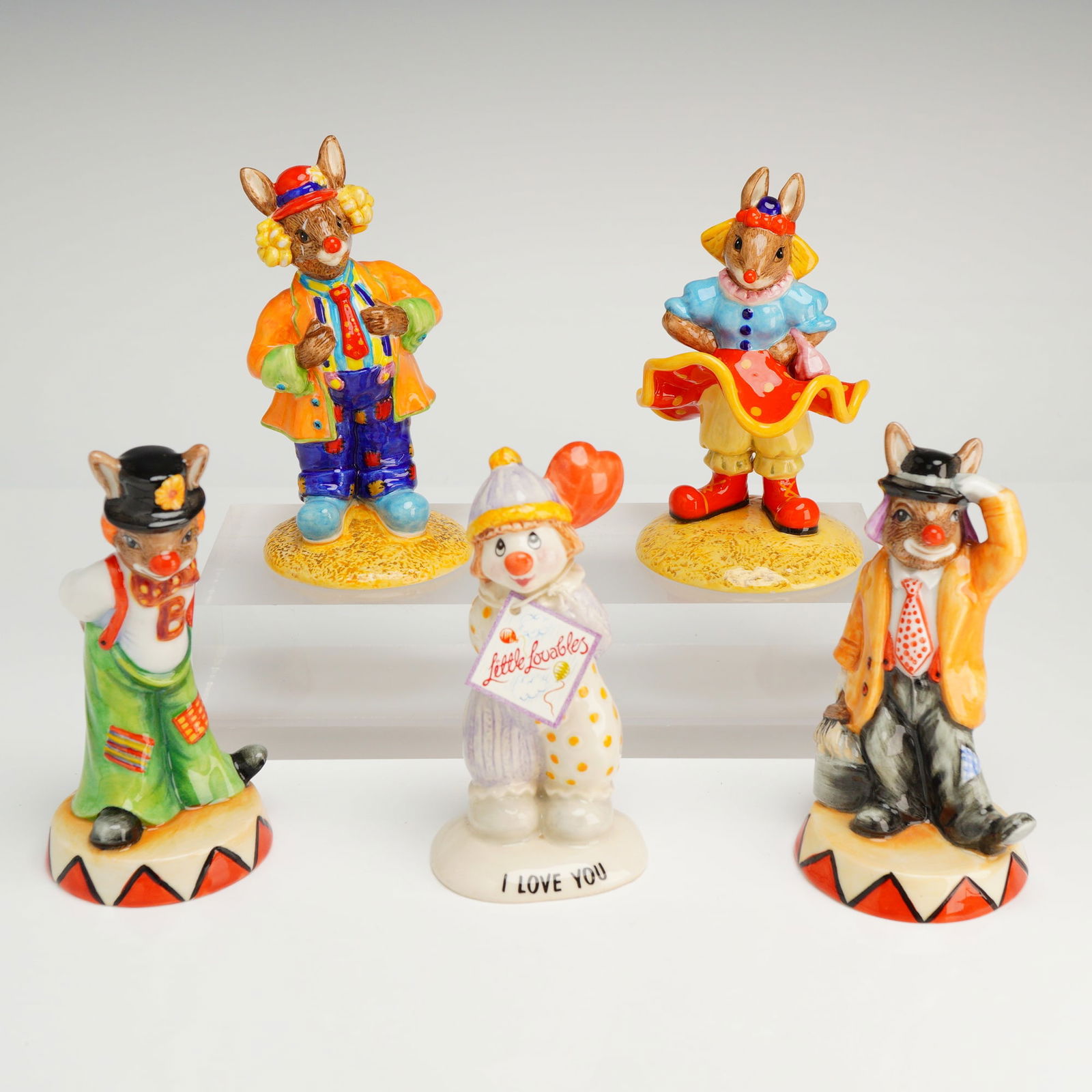 Five Royal Doulton Bunnykins and Beswick Clown Figurines: A collection of five multi-colored ceramic clown figurines by Royal Doulton (Bunnykins models Slap Dash DB468, Tip Toe DB469, Clarissa the Clown DB331, Clarence the Clown DB332) and Beswick (Little Lo