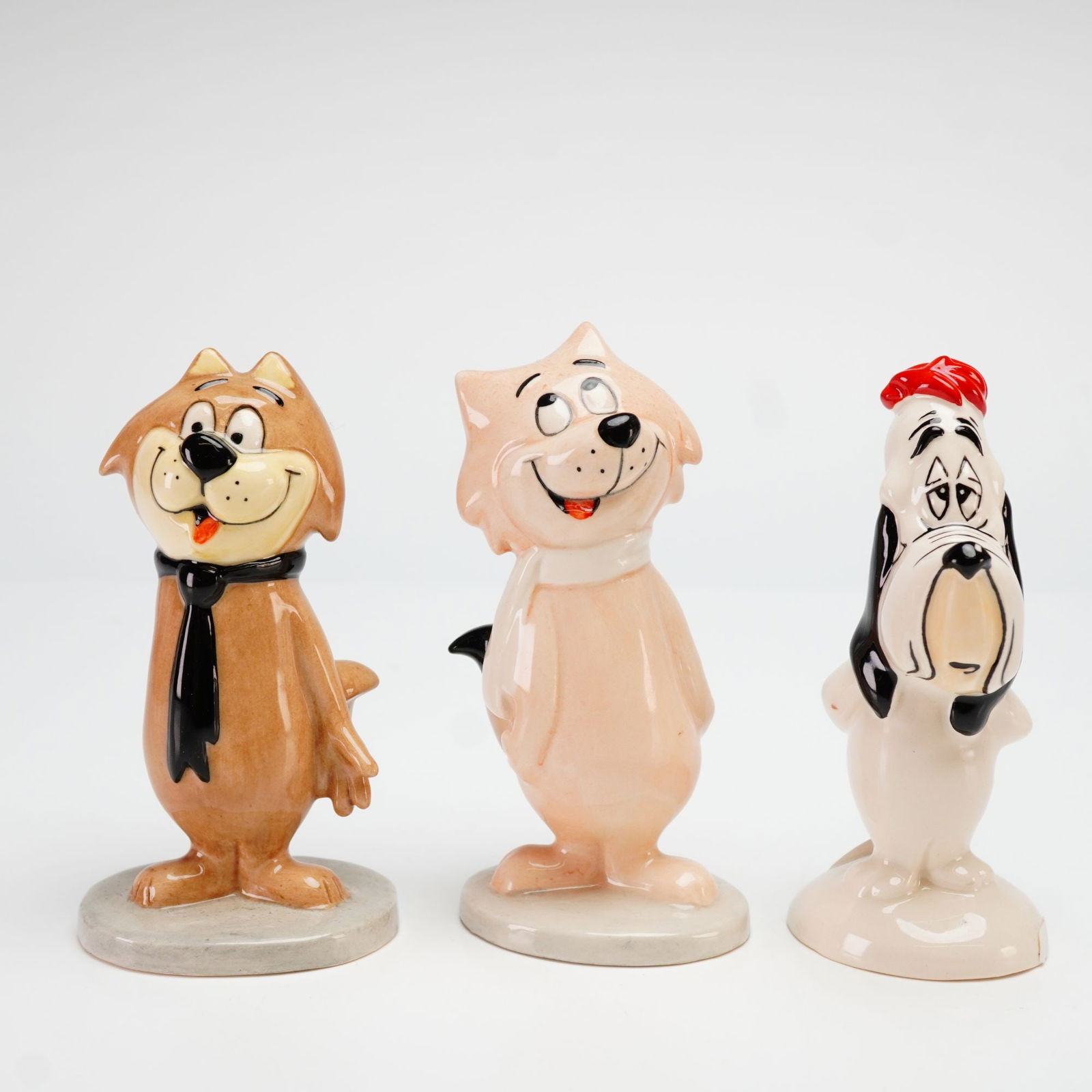 John Beswick Three Limited Edition Animated Character Figurines, 1990s.: John Beswick produced this set of three limited-edition glazed ceramic figurines for Royal Doulton, featuring iconic characters from Hanna-Barbera and MGM. The group includes Spook from Top Cat, produ