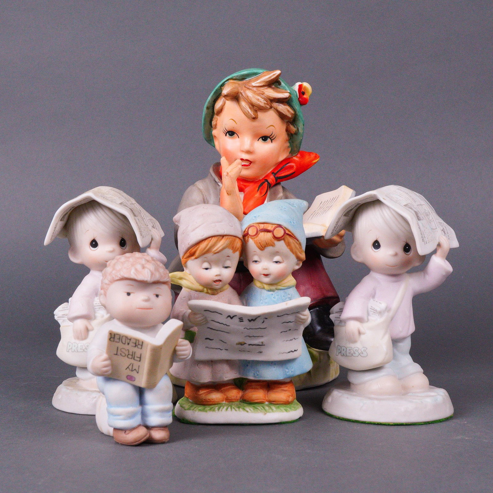 5pc Precious Moments and Clay in Mind Porcelain Figurines of Children: A group of five glazed and bisque porcelain figurines depicting children in a sentimental, collectible style, reminiscent of popular collectible lines such as Precious Moments. The grouping includes