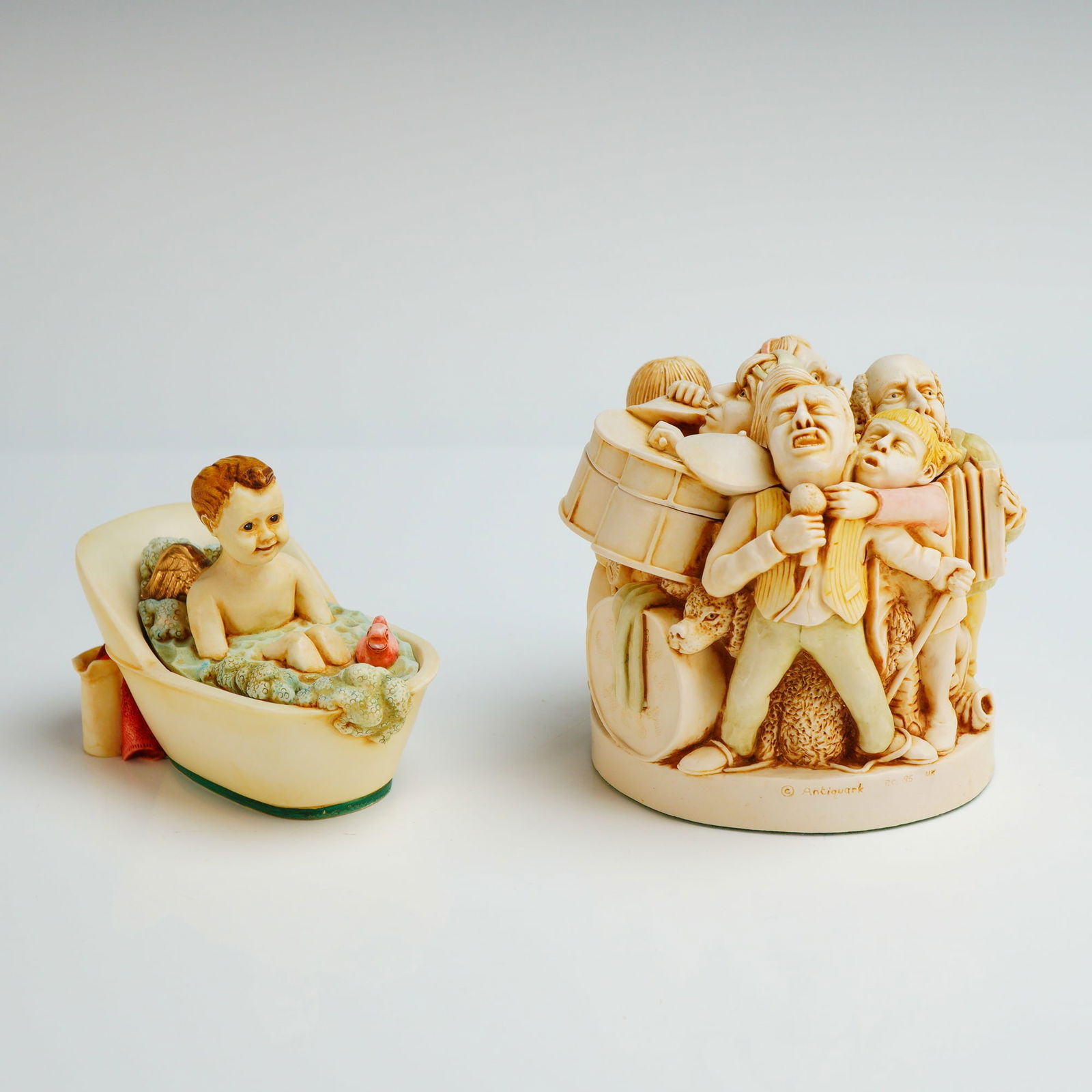 2pc Harmony Kingdom Trinket Boxes, Open Mike and Noel: The first piece, titled Open Mike from the Treasure Jest series, features a satirical scene of a musical band. The second piece, titled Noel from the Angetique series, depicts a winged cherub in a