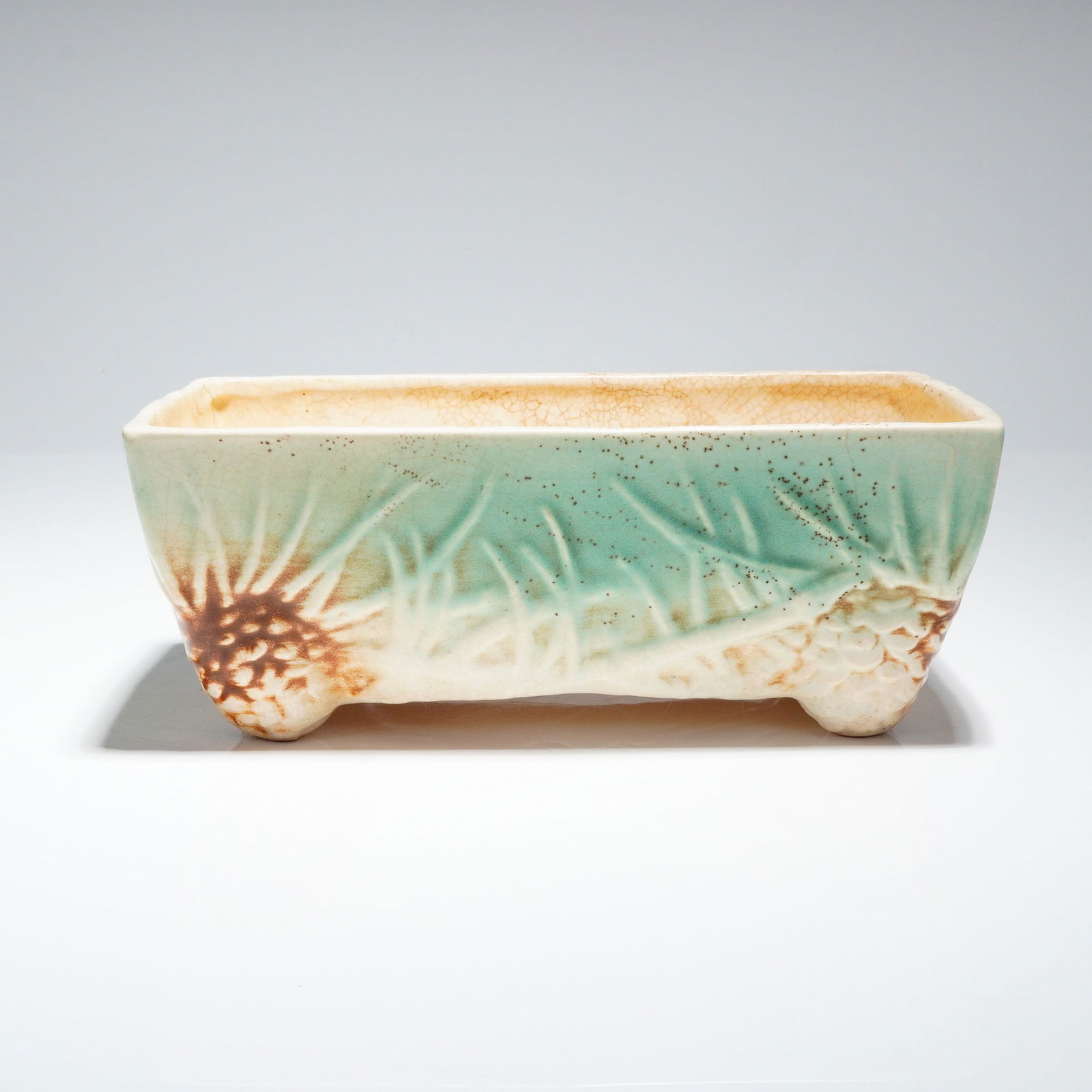 Vintage McCoy Rustic Pinecone Rectangular Window Box Planter: A single rectangular planter, identified as part of the McCoy Rustic Line Pinecone pottery series. This vintage McCoy Pinecone rectangular pottery piece is constructed of glazed earthenware and rests