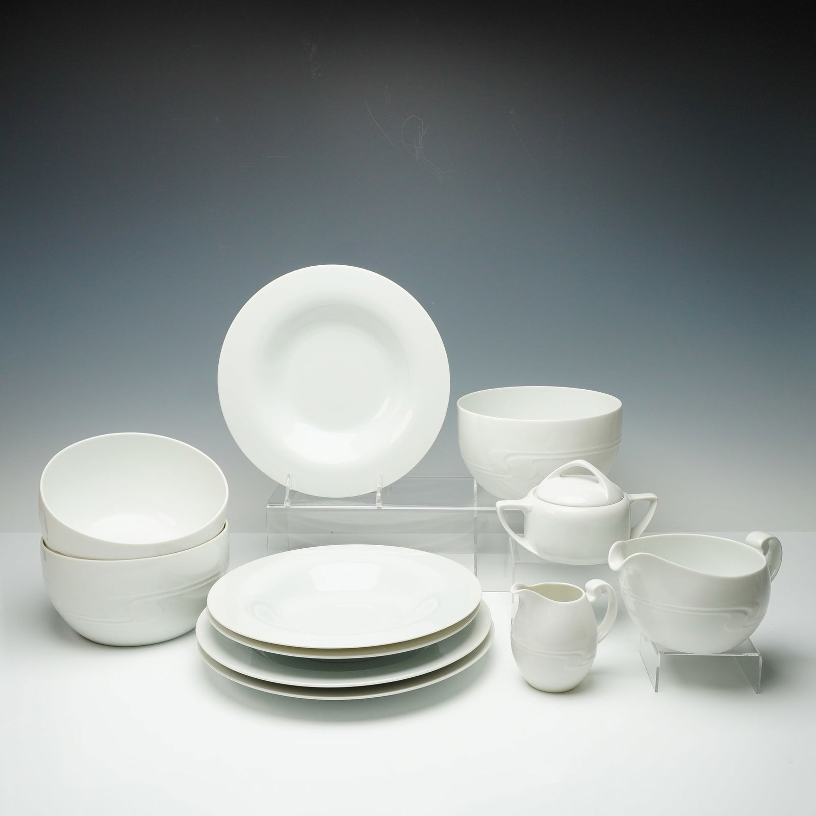 Coll. of 11 Rosenthal studio-linie Asimmetria Porc. Tableware Items: A collection of 11 items of white porcelain tableware from the Rosenthal studio-linie, in the Asimmetria pattern designed by Bjorn Wiinblad. The set is executed in a stark white glaze and features the