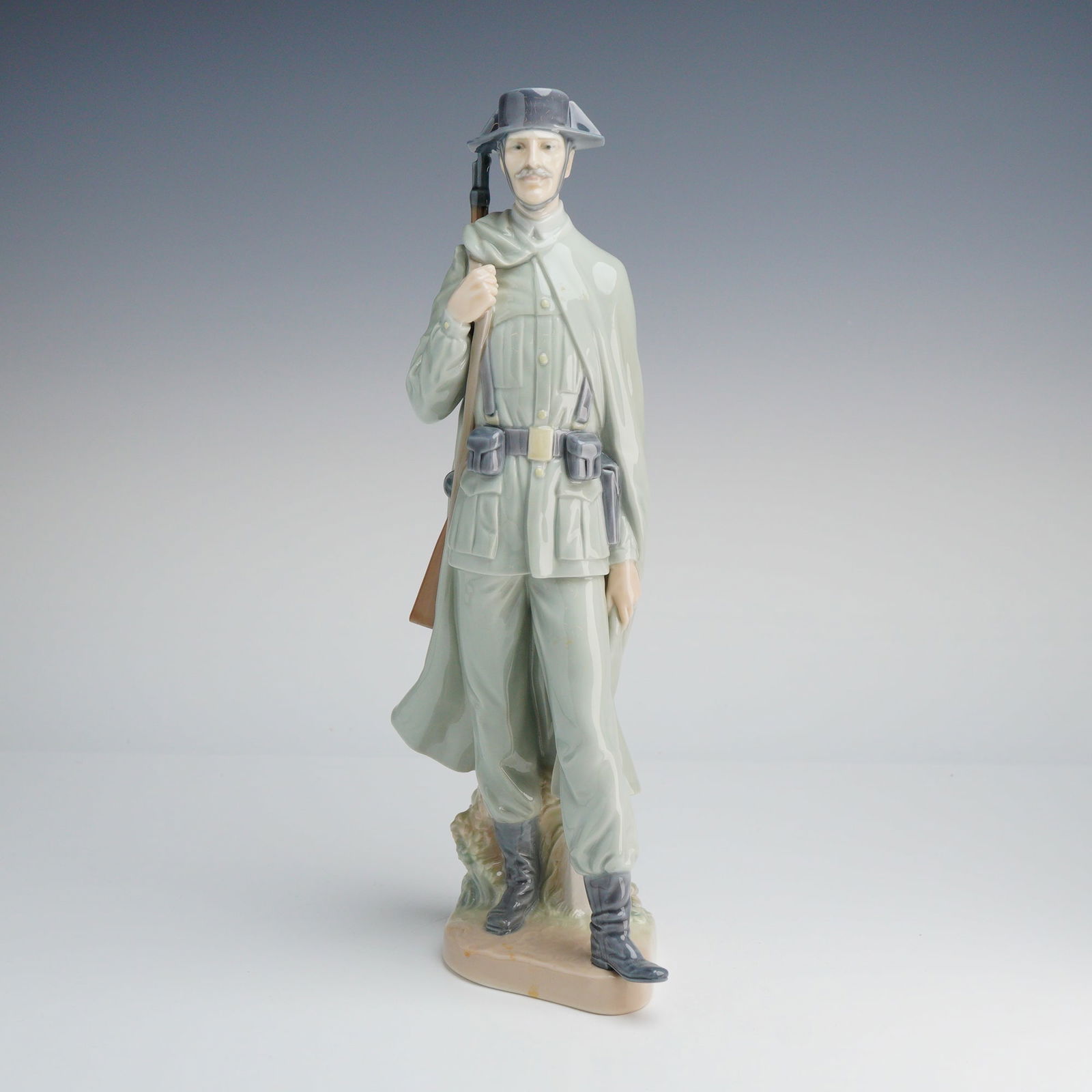 Lladro Porcelain Figurine Spanish Policeman Number 01004889: A Lladro porcelain figurine titled Spanish Policeman, model number 01004889, depicting a uniformed member of the Spanish Civil Guard (Guardia Civil). The standing figure is finished in a high-gloss