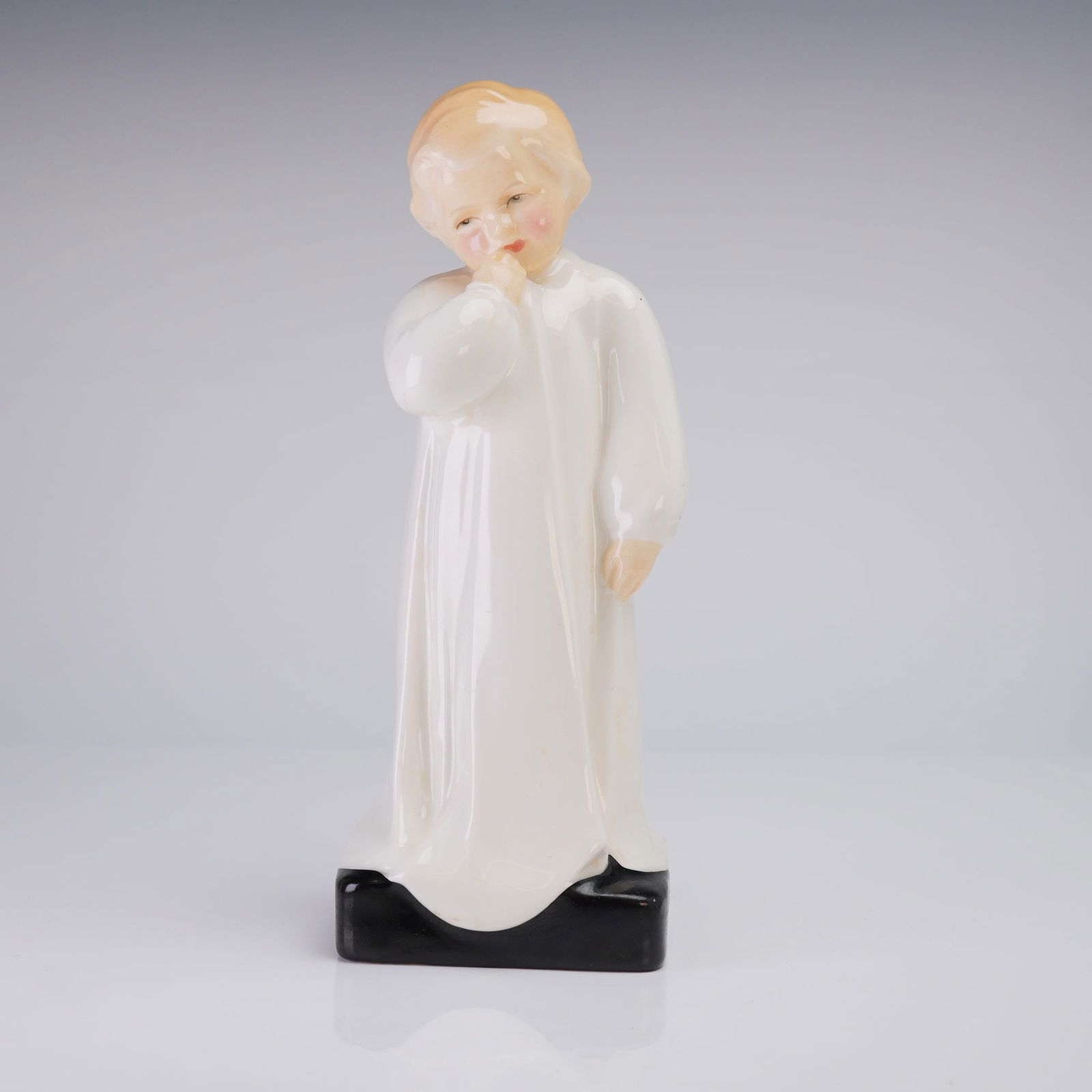 Royal Doulton Bone China Figurine Darling HN1319: A single Royal Doulton Bone China Figurine, Darling (HN1319), featuring a child in white robes on a black base, marked on the underside with the title and maker's stamp. Dimensions: 3.00"L x 3.25"W