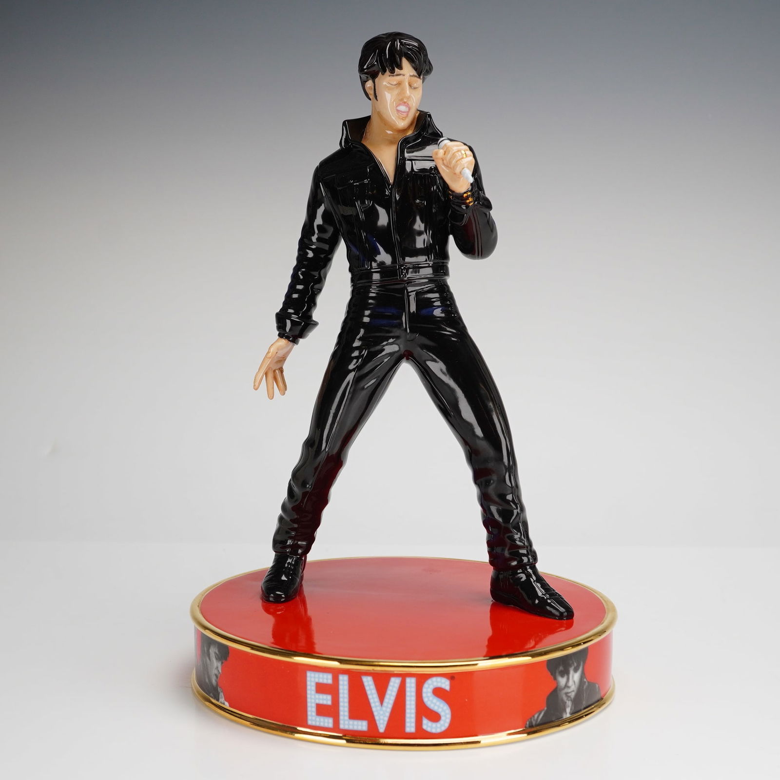 Royal Doulton Elvis Stand Up EP2 Figurine: This Royal Doulton figurine, titled Elvis Stand Up EP2, is a porcelain study of Elvis Presley depicting his appearance in the 1968 Comeback Special. The figure is shown in a black leather outfit and