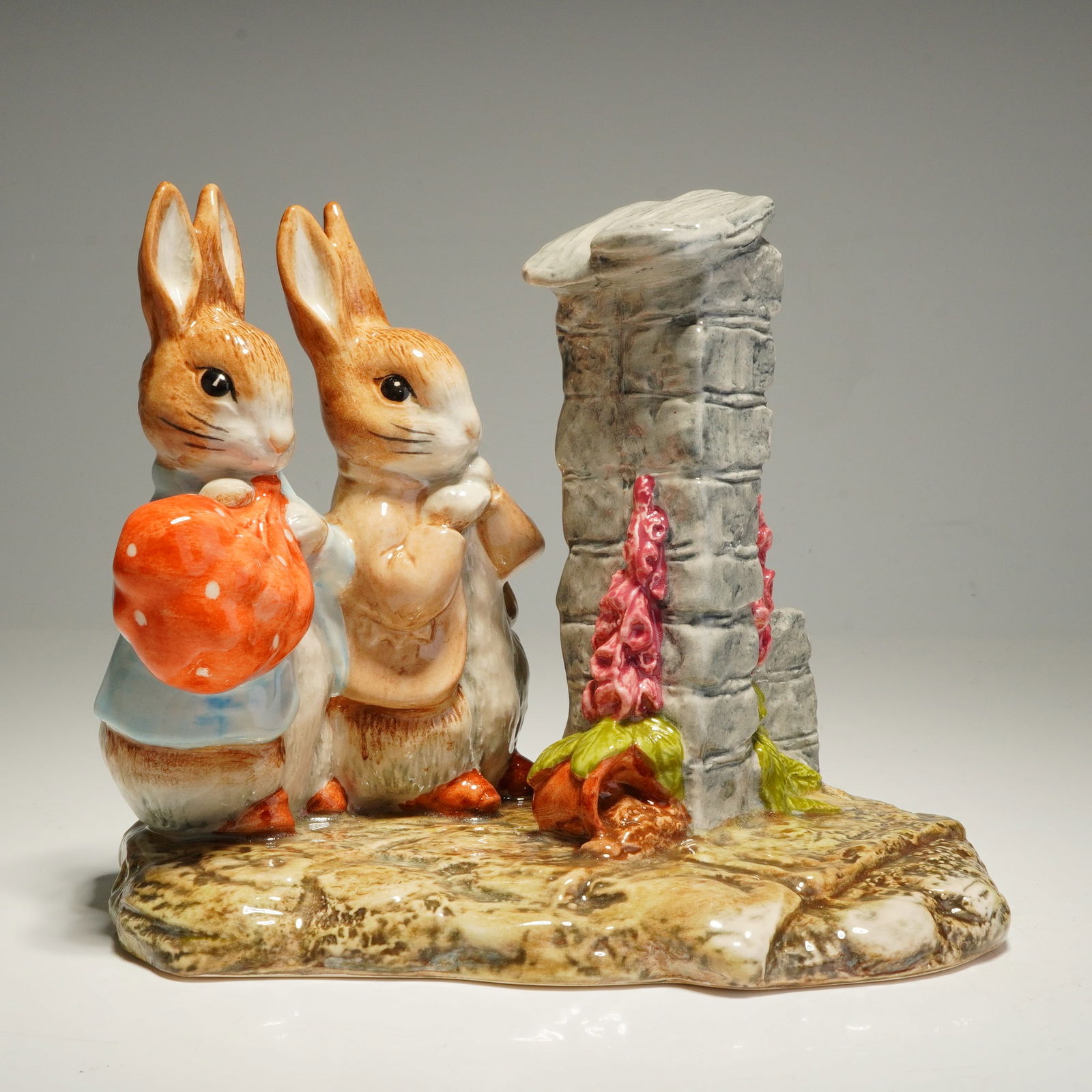 Beswick Beatrix Potter Tableau Hiding from the Cat: A Beswick Ware ceramic tableau titled Hiding from the Cat from the World of Beatrix Potter. This hand-painted figurine features the anthropomorphic rabbits Peter Rabbit and Benjamin Bunny. Peter Rabbi