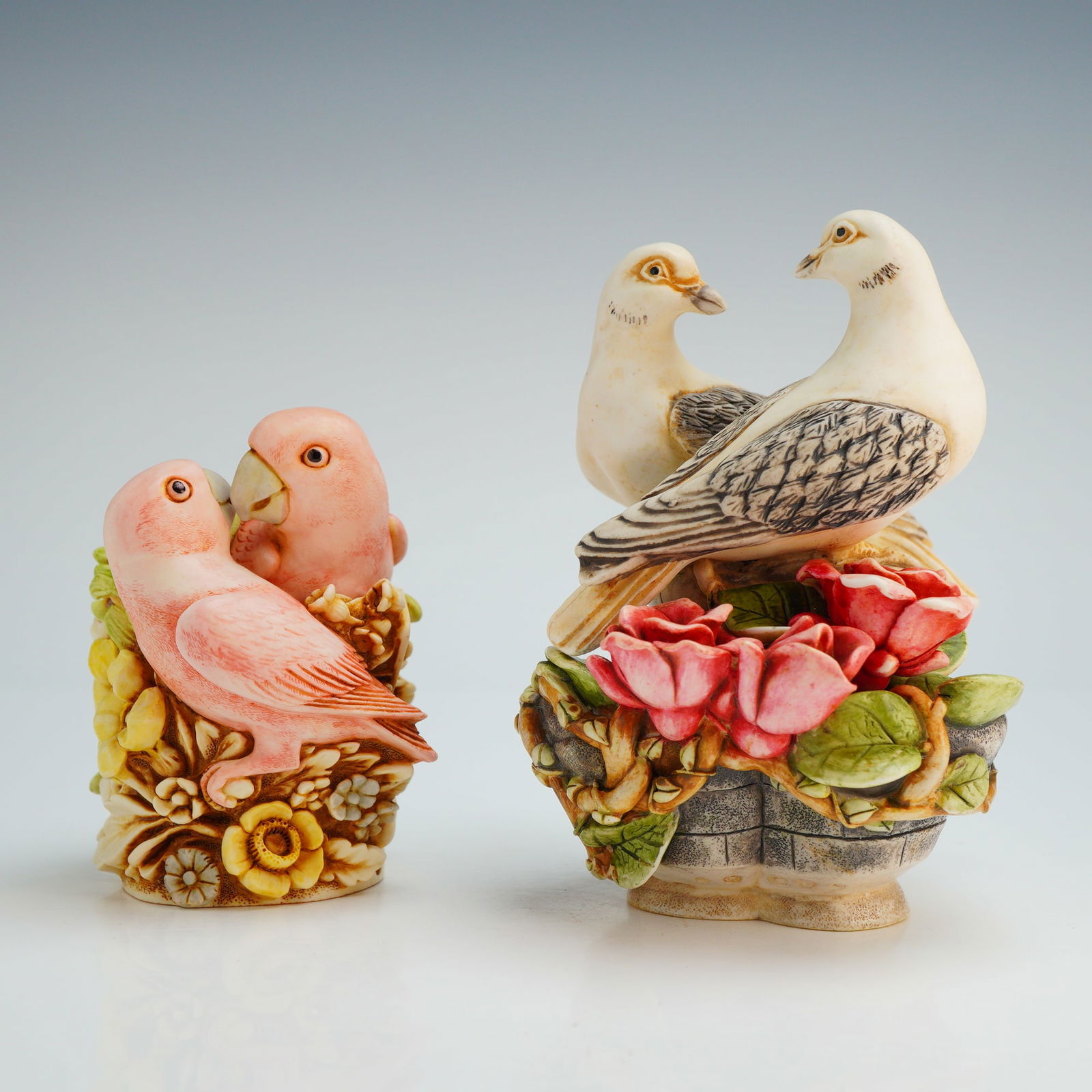 2pc Harmony Kingdom Trinket Boxes, Love Nest and Love & Peace: From the Romance Annual collection, featuring the Love Nest and Love & Peace patterns. The Love Nest (TJSER98) piece depicts two pink cockatoos nestled within a dense floral arrangement. The Love & Pe