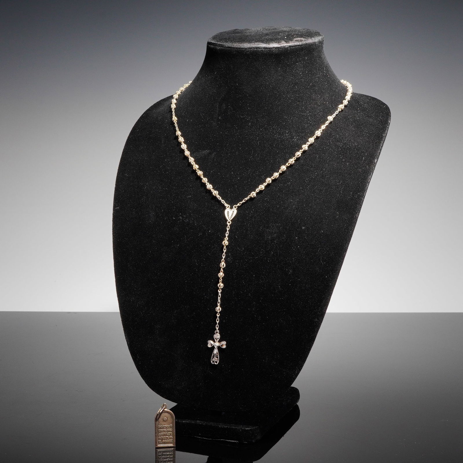 2pc Silver Rosary and Russian Cathedral Pendant: This lot consists of two religious items. The primary item is a silver rosary necklace constructed of links connecting spherical beads. The chain leads to a heart-shaped openwork filigree junction pie