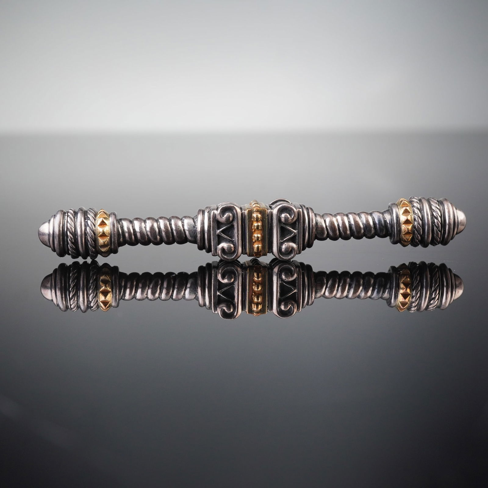 Esti Frederica Sterling Silver and 18K Gold Bar Brooch: Esti Frederica Sterling Silver and 18K Gold Bar Brooch. This elongated brooch features a symmetrical composition with a central decorative panel exhibiting stylized motifs, flanked by sections of twis