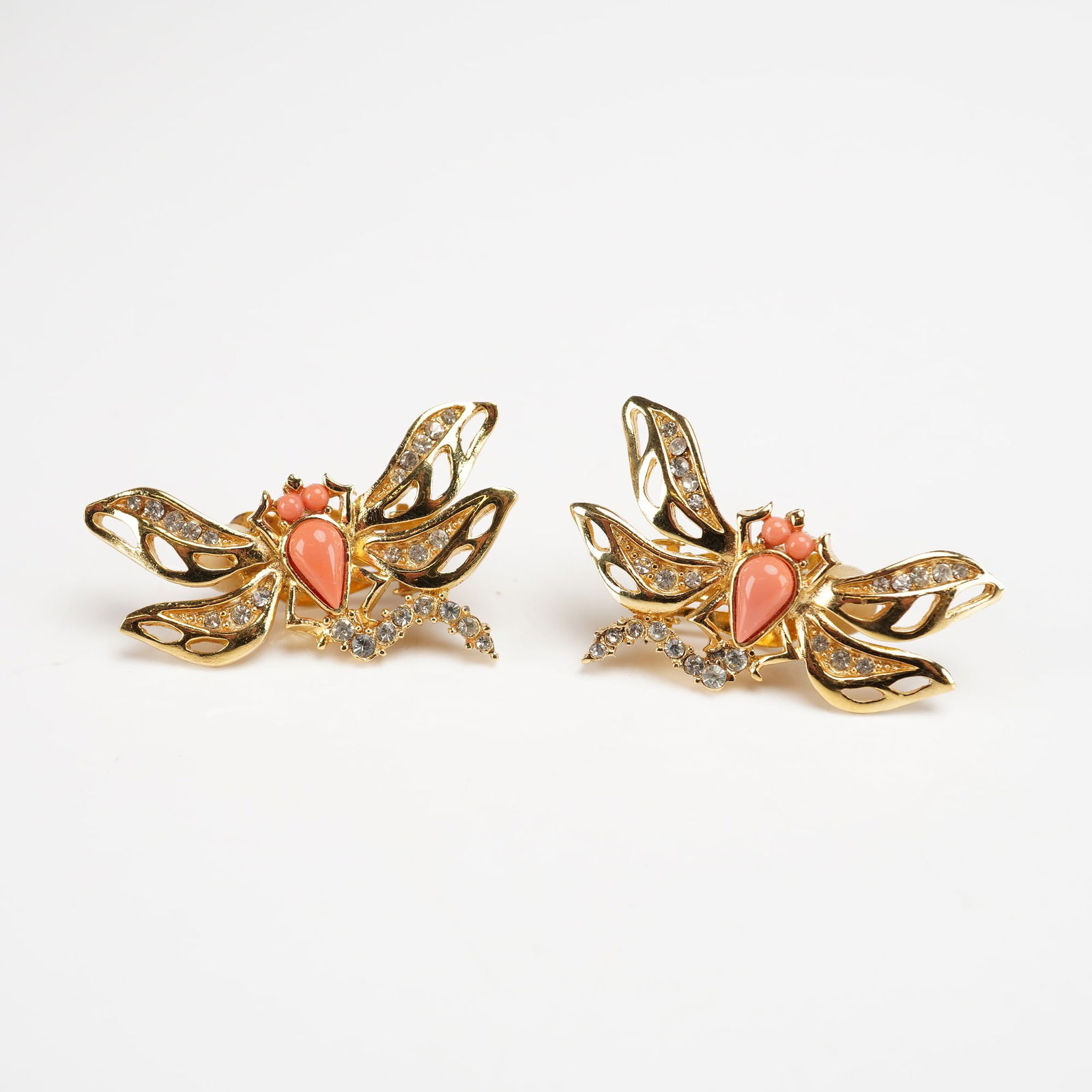 Pair of Givenchy Gold-Plated Figural Dragonfly Clip-On Earrings: A pair of designer costume jewelry clip-on earrings by Givenchy. These figural pieces are executed in gold-plated metal, designed in the form of stylized dragonflies or winged insects. The openwork wi