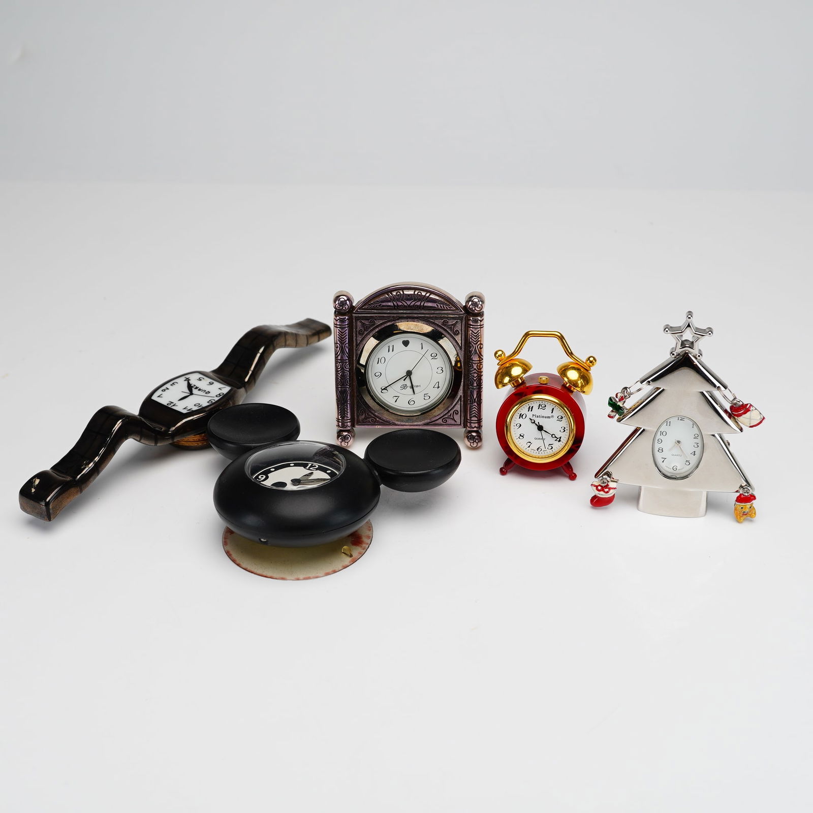 Collection of 5 Novelty Miniature Clocks by Disney, Brighton, and Platinum: The group features a black Mickey Mouse-shaped clock marked Disney and Japan Movt, an ornate silver-tone mantel-style clock by Brighton with scrolled engravings and heart motif, and a miniature red al