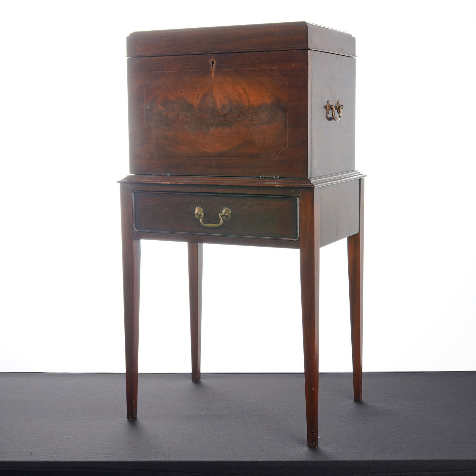 Henkel Harris Virginia Galleries Mahogany Silver Chest on Stand: A Henkel-Harris Virginia Galleries mahogany silver chest on stand. The piece features a rectangular chest with a hinged lid and a drop-front panel that reveals an interior fitted with three drawers an