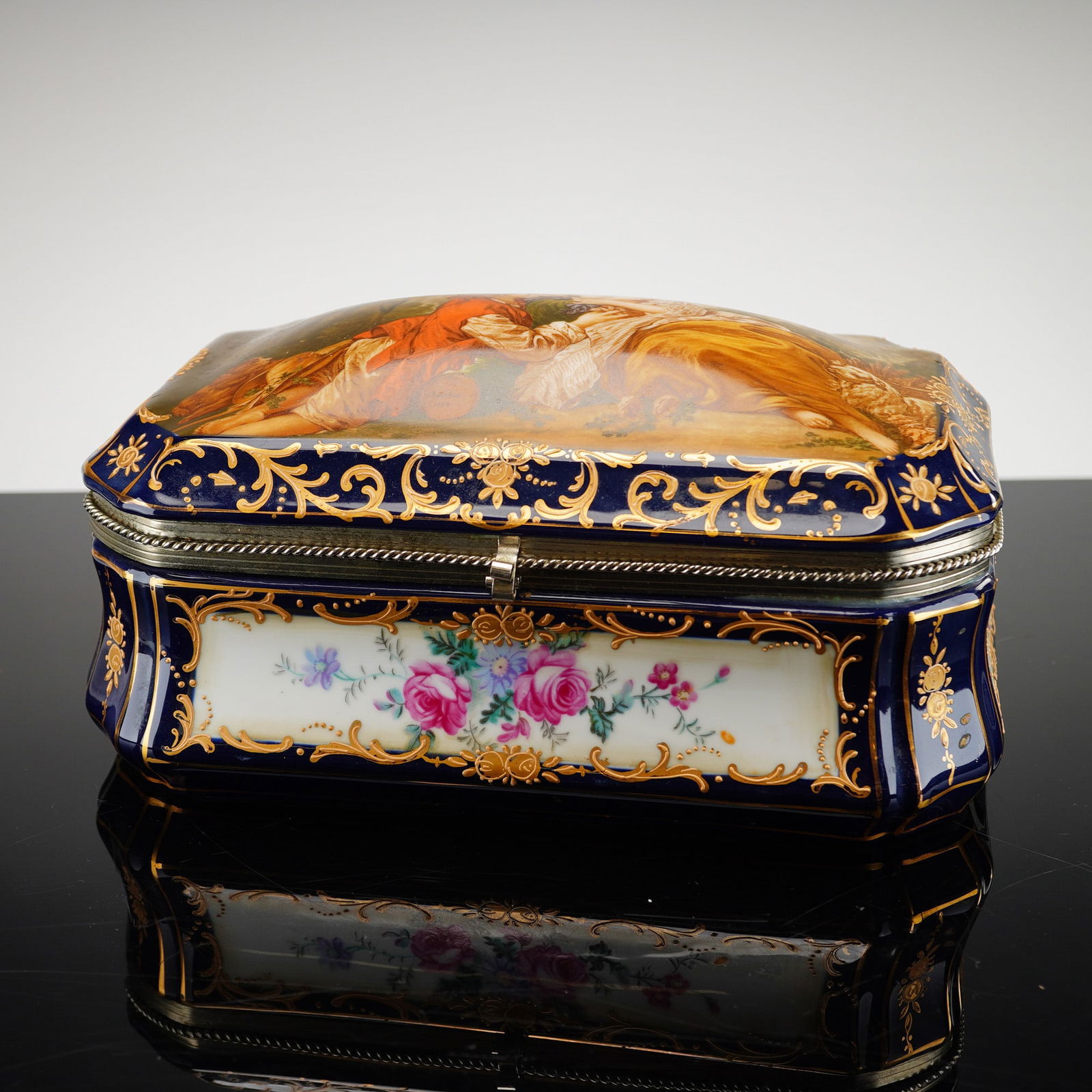 After Reinhold Schlegelmilch Prussia Porcelain F. Boucher Vanity Box: Inspired by a Prussian hand-painted porcelain vanity box, featuring a rectangular serpentine shape with a rich cobalt blue ground accented by gilded decoration. The hinged domed lid features a large c