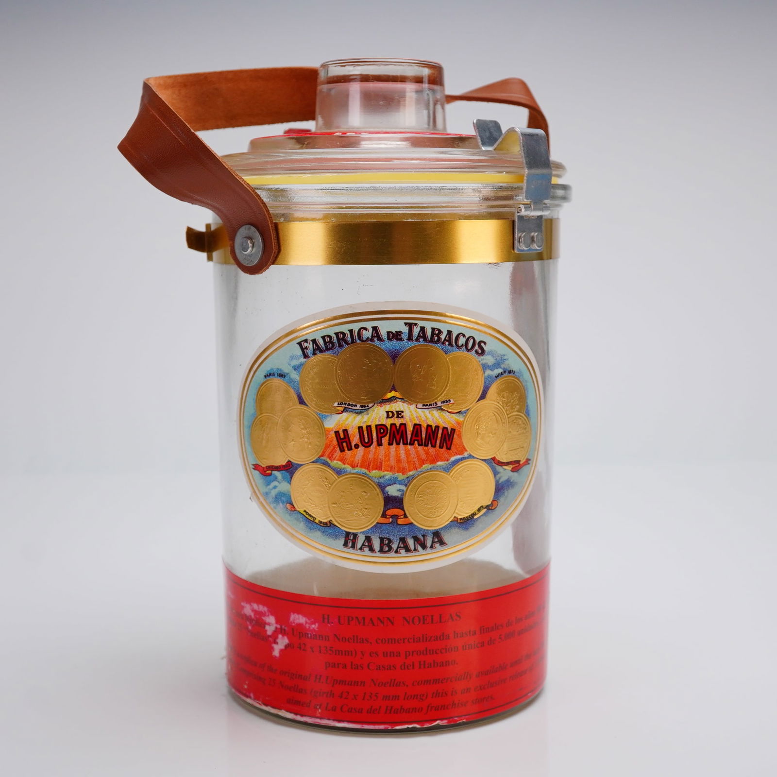 H. Upmann Noellas Cuban Glass Cigar Humidor Jar: A single modern cylindrical glass cigar jar, known as the H. Upmann Noellas Jar, typically produced exclusively for La Casa del Habano (LCDH). This collectible Cuban glass cigar jar features a clear b