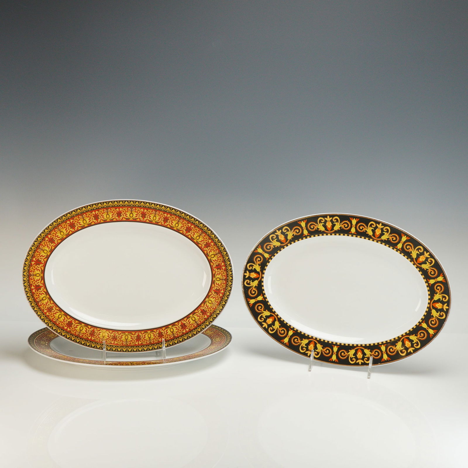 3pc Rosenthal Versace Porcelain Oval Platters, Barocco & Medusa: Porcelain oval platters one representing the Barocco design and two with the Medusa pattern. Each platter is finely crafted in high-quality porcelain and showcases Versace's signature Baroque-inspired
