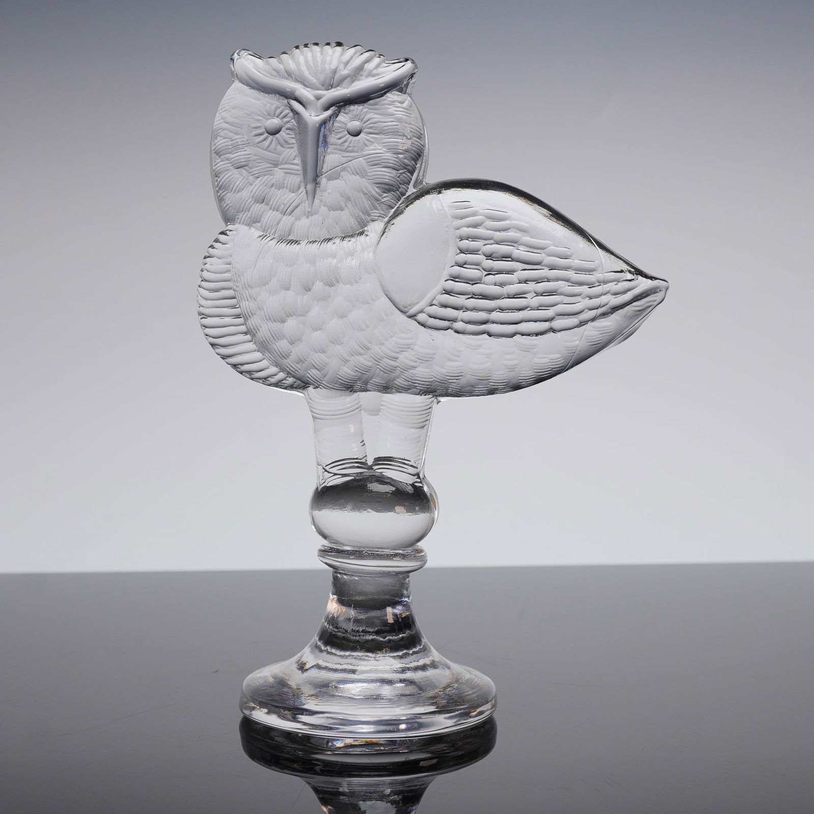 Kosta Boda Clear Art Glass Owl Figurine: A vintage Kosta Boda Art Glass Owl figurine sculpture. The single figurative object is executed in heavy, clear, colorless pressed glass, featuring molded detail rendering feather textures across the