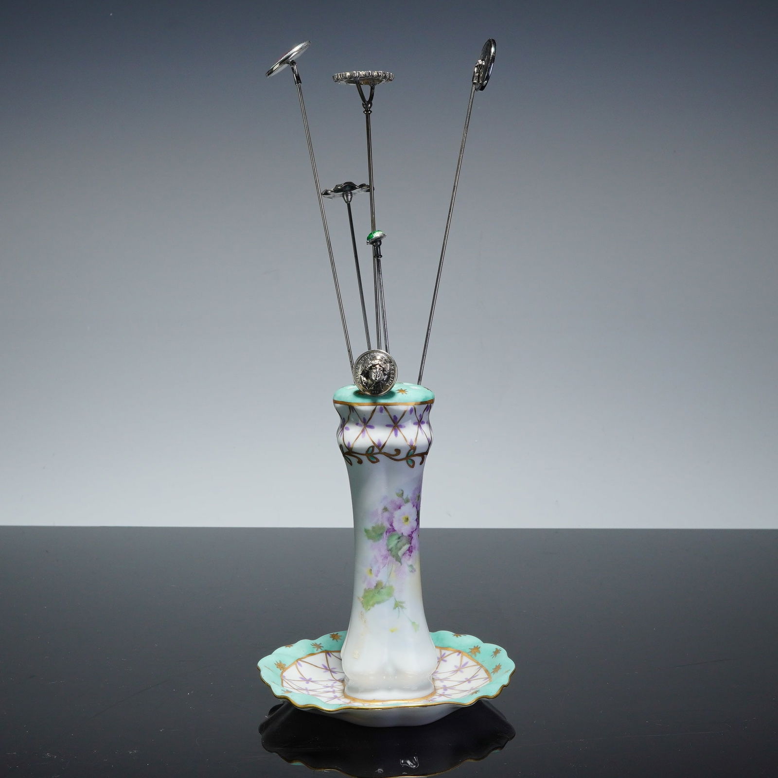 Paris Royal Hat Pin Holder with Sterling Silver Pins: This collection features six decorative hat pins with 4 marked sterling silver presented in a hand-painted porcelain hat holder. The pins include two sterling silver circular heads with pink guilloche
