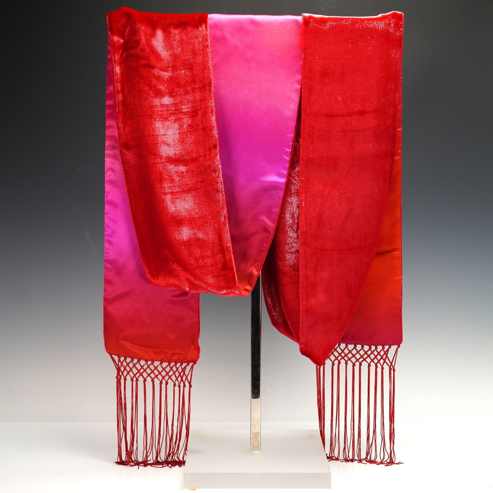 ESCADA Made in Italy Silk Blend Gradient Scarf with Macrame Fringe: An ESCADA contemporary textile wrap or scarf, Made in Italy. Crafted from a lustrous fabric, displaying a vibrant color gradient from fuchsia pink to a rich, textured red with a subtly crushed or crin