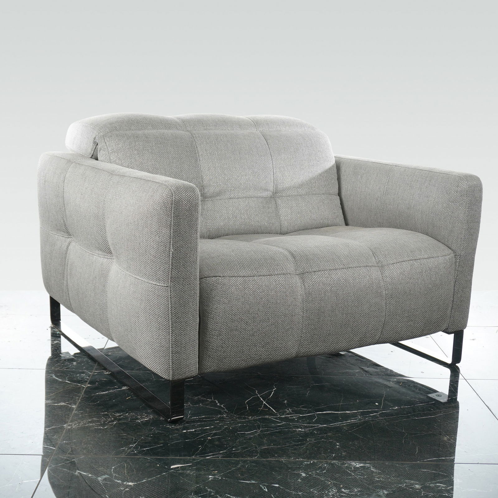 Natuzzi Italia Philo Oversize Power Reclining Armchair: This contemporary Natuzzi Italia Philo armchair is made in Italy and features an upholstered light grey textured fabric with a subtle grid-patterned tufting across the seat, interior backrest, and ext