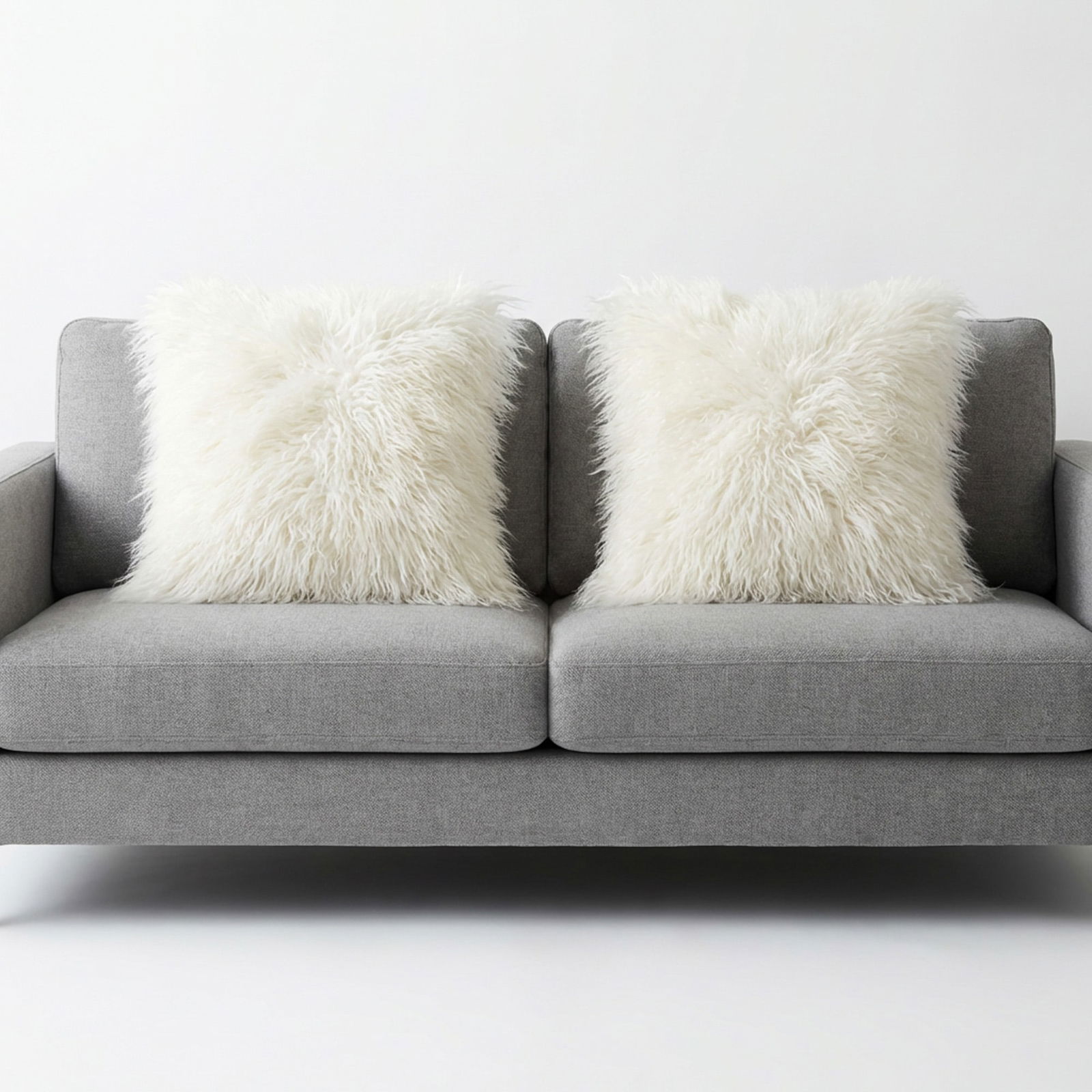 3pc West Elm Mongolian Lamb and Geo Channel Decorative Pillow Covers: A collection of three decorative pillow covers by West Elm. The set includes one Geo Chenille Jacquard pillow cover featuring a textured geometric cut velvet fabric. Also included are two white West E