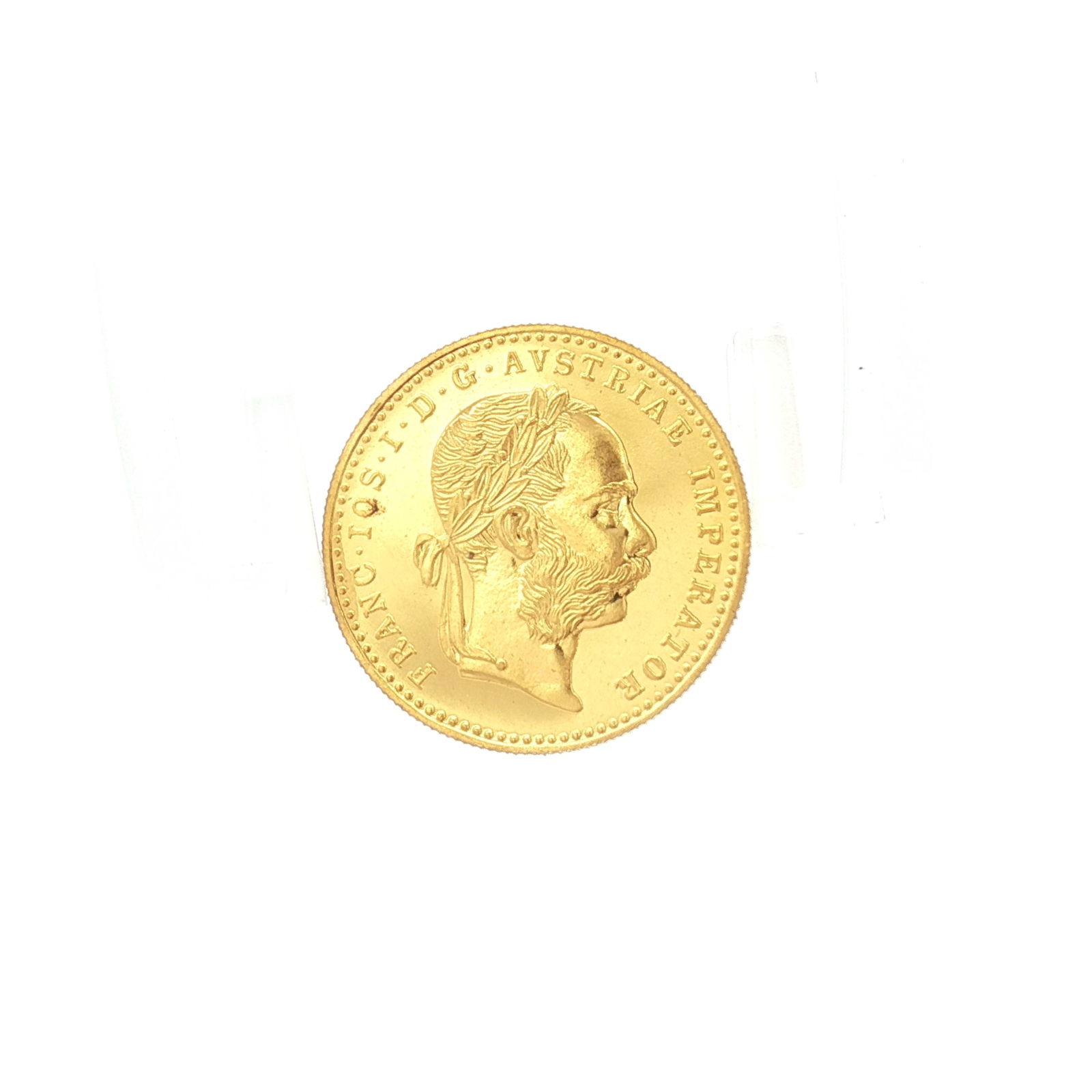 1915 Austria 1 Ducat Frances Joseph I Gold Coin: The obverse depicts bust of Franz Joseph right-facing with FRANC IOS I D G AUSTRIAE IMPERATOR. The reverse displays HUNGAR BOHEM GAL LOD ILL REX AA 1915. The coin is housed in a Jefferson Coin & Bulli