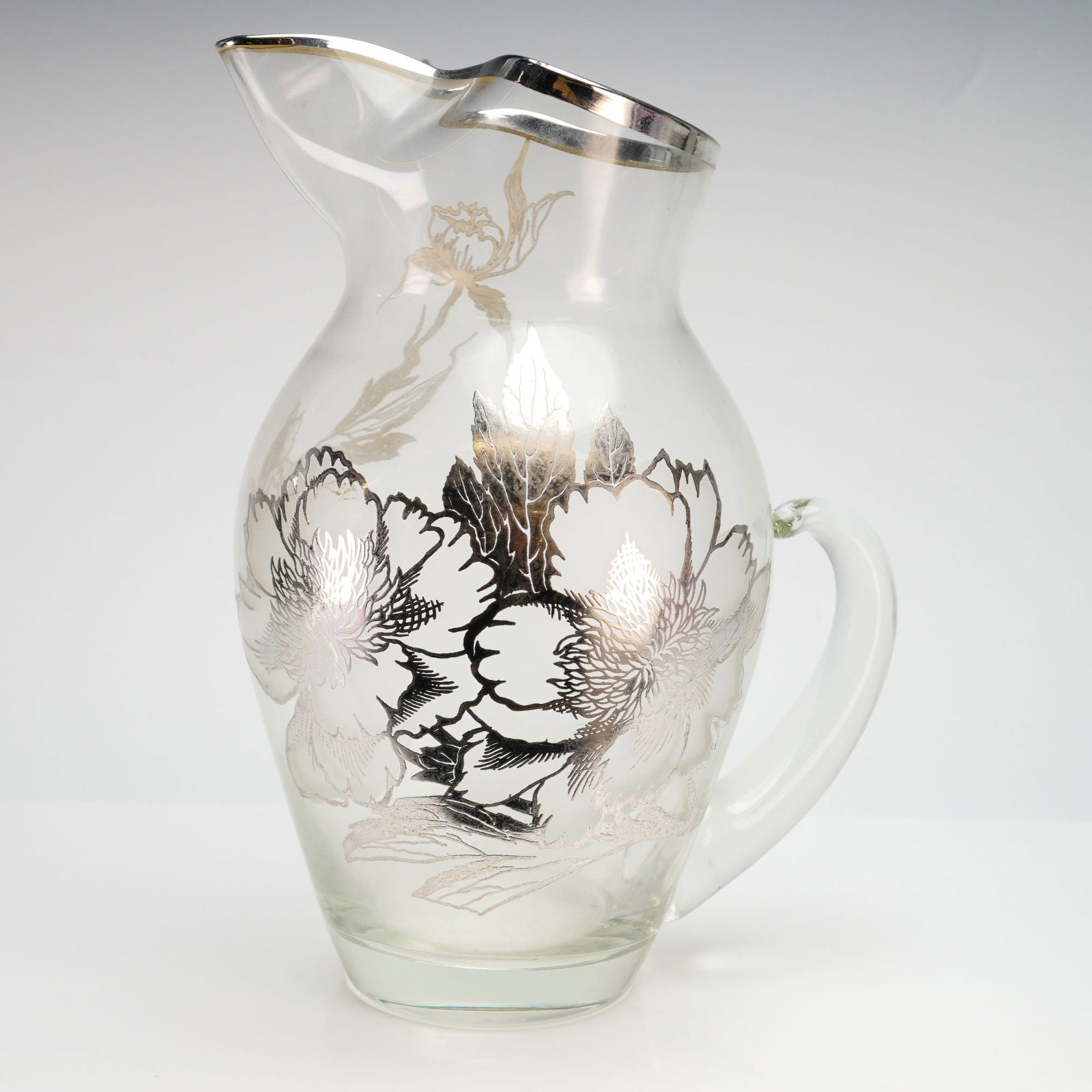 Silver City Flanders Poppy Clear and Silvery Overlay Pitcher: This vintage clear glass pitcher features the Flanders poppy pattern in silver overlay, manufactured by the Silver City Glass Company. The design showcases large, stylized floral motifs with detailed