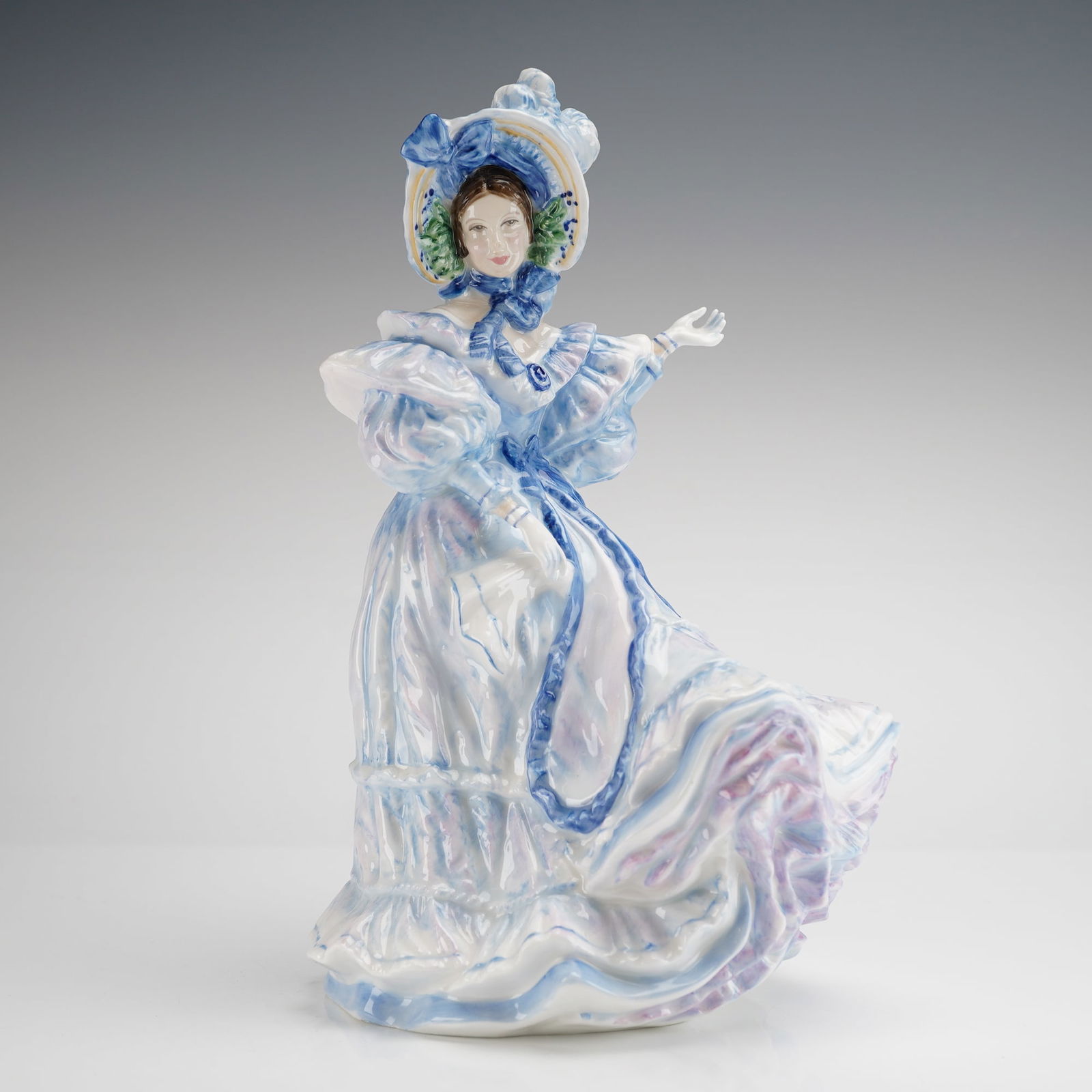 Royal Doulton Figurine Forget-Me-Nots HN 3700: A single glazed ceramic figurine from the Royal Doulton Flowers of Love collection, titled Forget-Me-Nots. The figurine is constructed of bone china and modeled as a 19th-century lady wearing an elabo