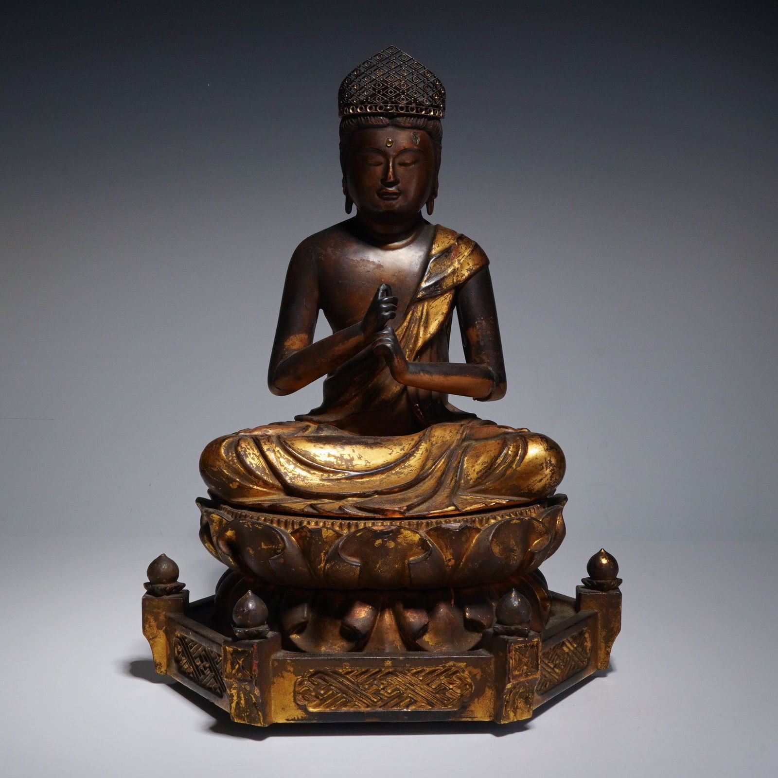 Japanese Lacquer and Gilt Wood Figure of Dainichi Nyorai: This Japanese wooden sculpture depicts Dainichi Nyorai (Mahavairocana) carved from wood with a dark lacquered surface and remnants of gilding. The figure is seated in padmasana on a multi-tiered lotus