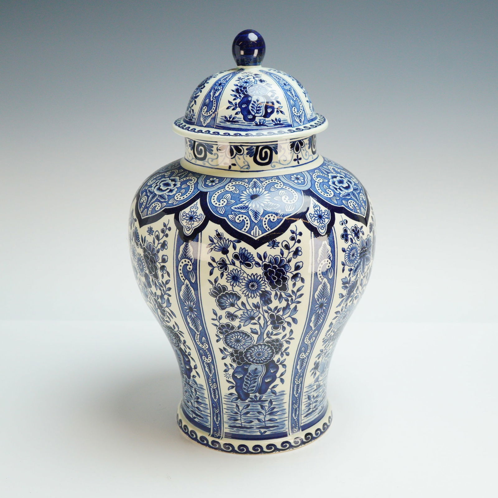 Royal Sphinx by Boch Delft Blue Porcelain Lidded Jar: This porcelain lidded jar was made for Royal Sphinx by Boch in the traditional Delft Blue style. The vessel is of baluster form with a matching domed lid and a rounded finial. The exterior decoration