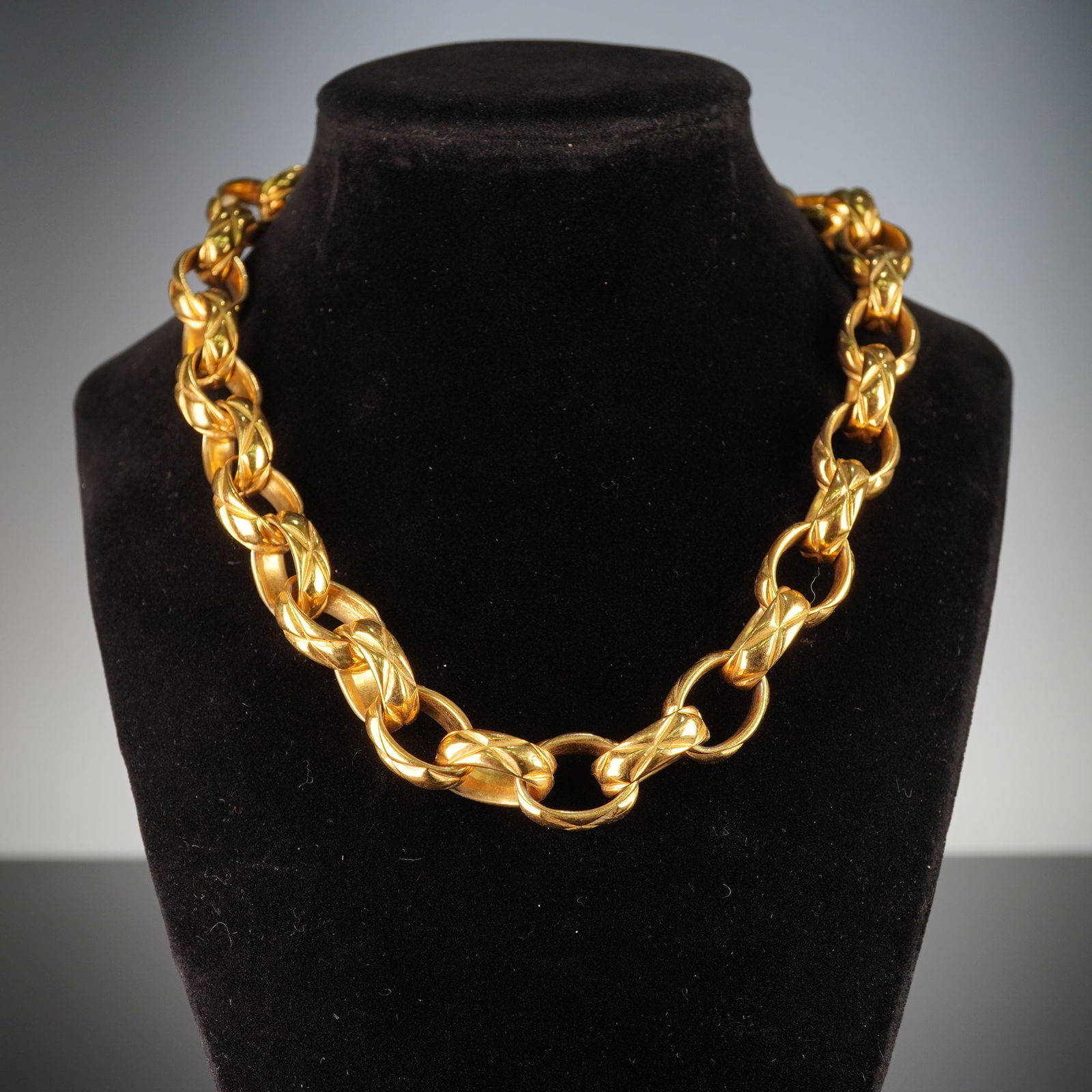 Chanel Paris Quilted Chain Link Gold-Tone Choker Necklace: A Chanel Paris quilted chain link gold-tone choker necklace featuring a bold, chunky link design. This Chanel choker necklace is composed of substantial quilted gold-tone chain links, designed in a bo