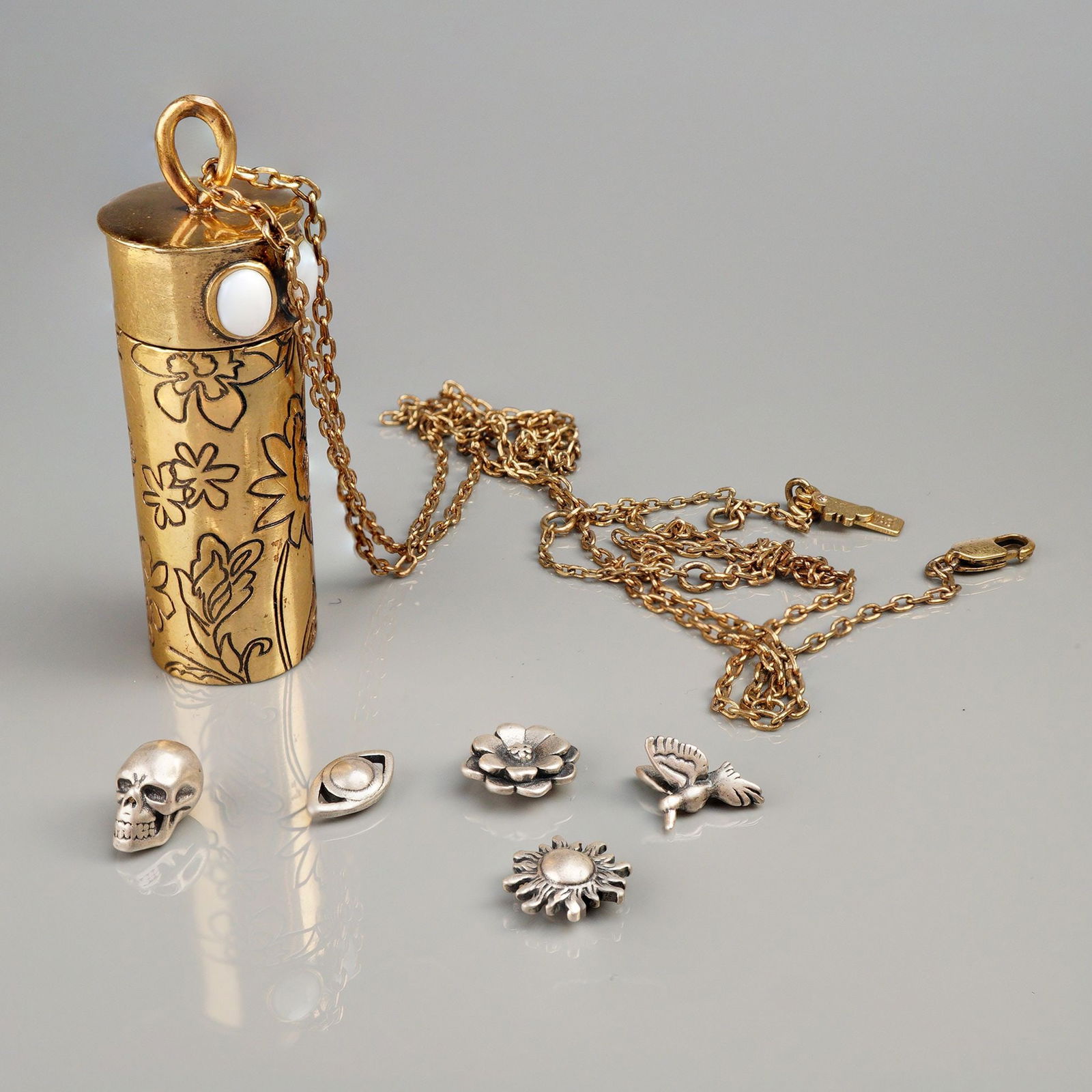 Johnny Was Floral Talisman Charm Pendant Necklace w/Sterling Silver Charms: Brass, engraved floral detail with mother of pearl stones. Top screws off and inside are 5 tiny sterling silver charms to bring luck and protection. Johnny Was tag. Dimensions: 32.00"L Weight: 38.75g