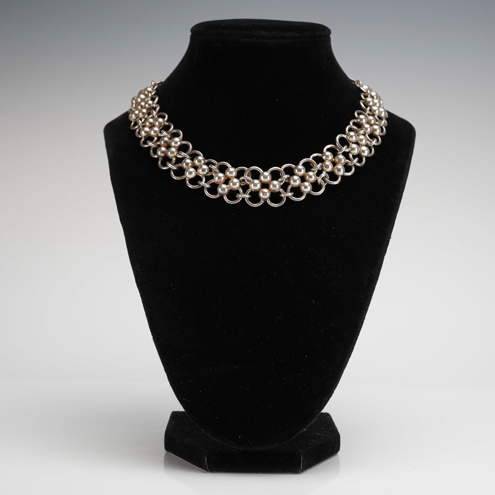 Mexican Sterling Silver Wide Link Chain Collar Necklace: A sterling silver collar necklace of Mexican origin. The wide, choker-style design features connected jump rings integrated with groups of four spherical beads to form a repetitive, net-like pattern.