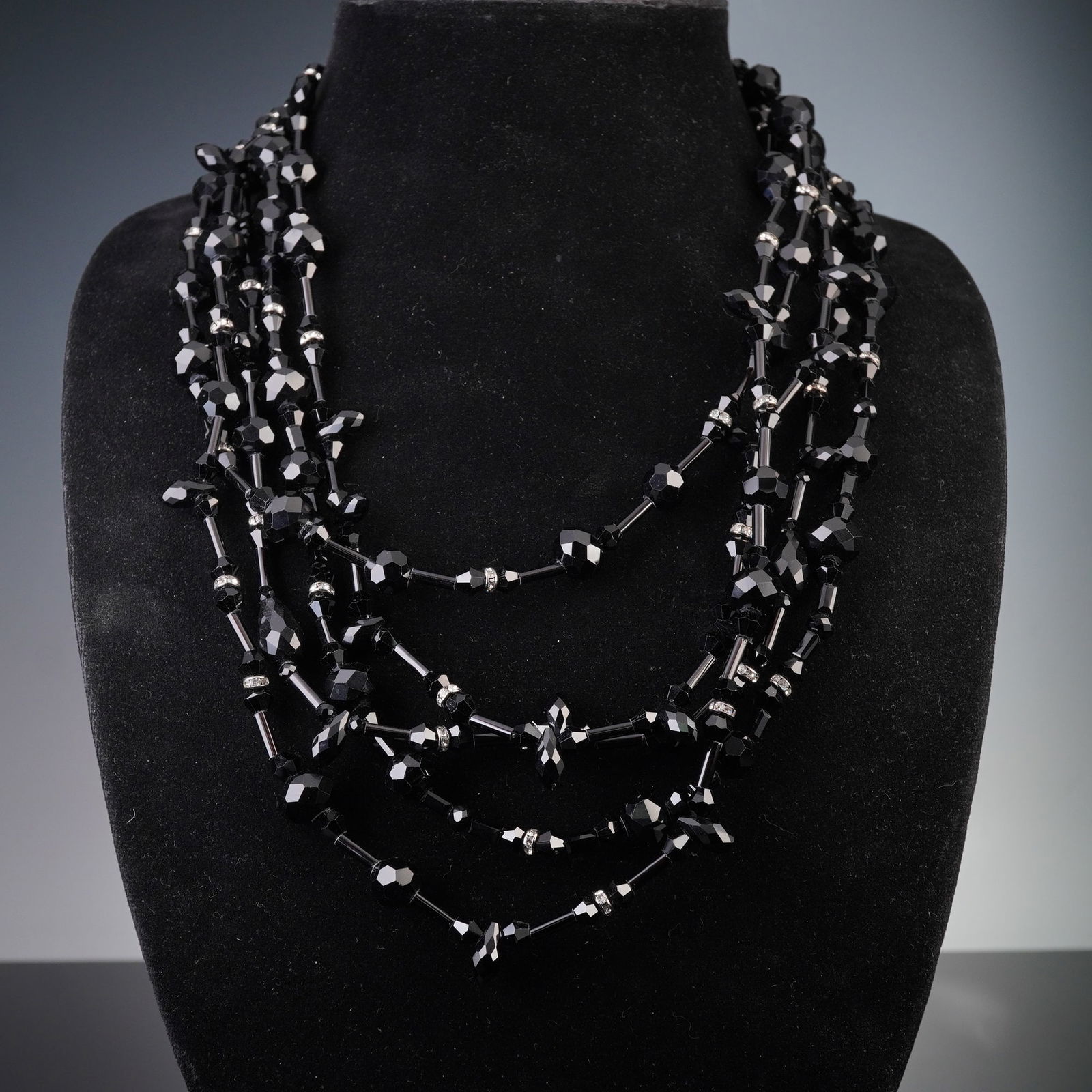 Weekend Max Mara Multi-Strand Black Faceted Bead Necklace: A Weekend Max Mara multi-strand black faceted bead necklace. Comprising five individual strands primarily made of black faceted beads of varying shapes (bicone, rondelle) and sizes, accented by smalle