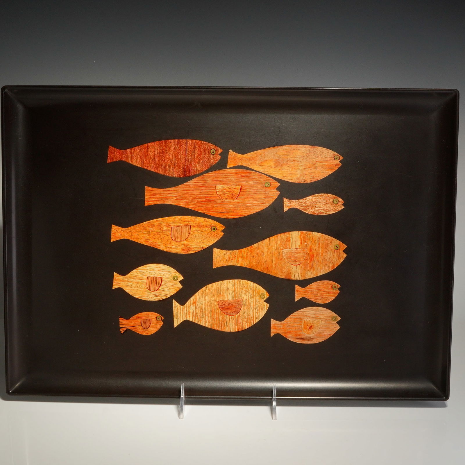 Couroc of Monterey Inlaid Fish Serving Tray: A Mid-Century Modern rectangular serving tray produced by Couroc of Monterey, California. The tray is composed of the company's signature black phenolic resin. The center features a hand-inlaid design